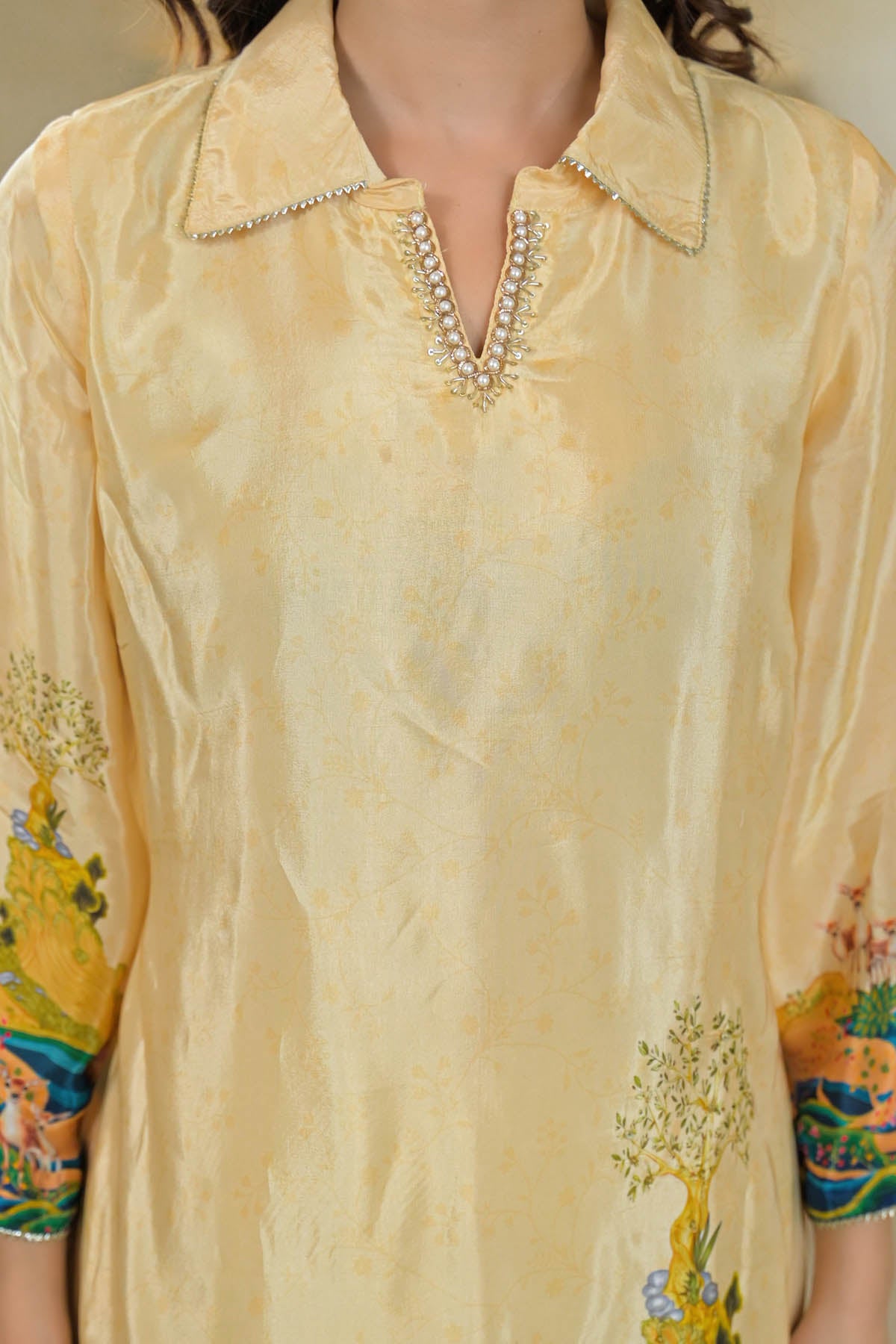 Beige shirt with floral sleeves and collar details