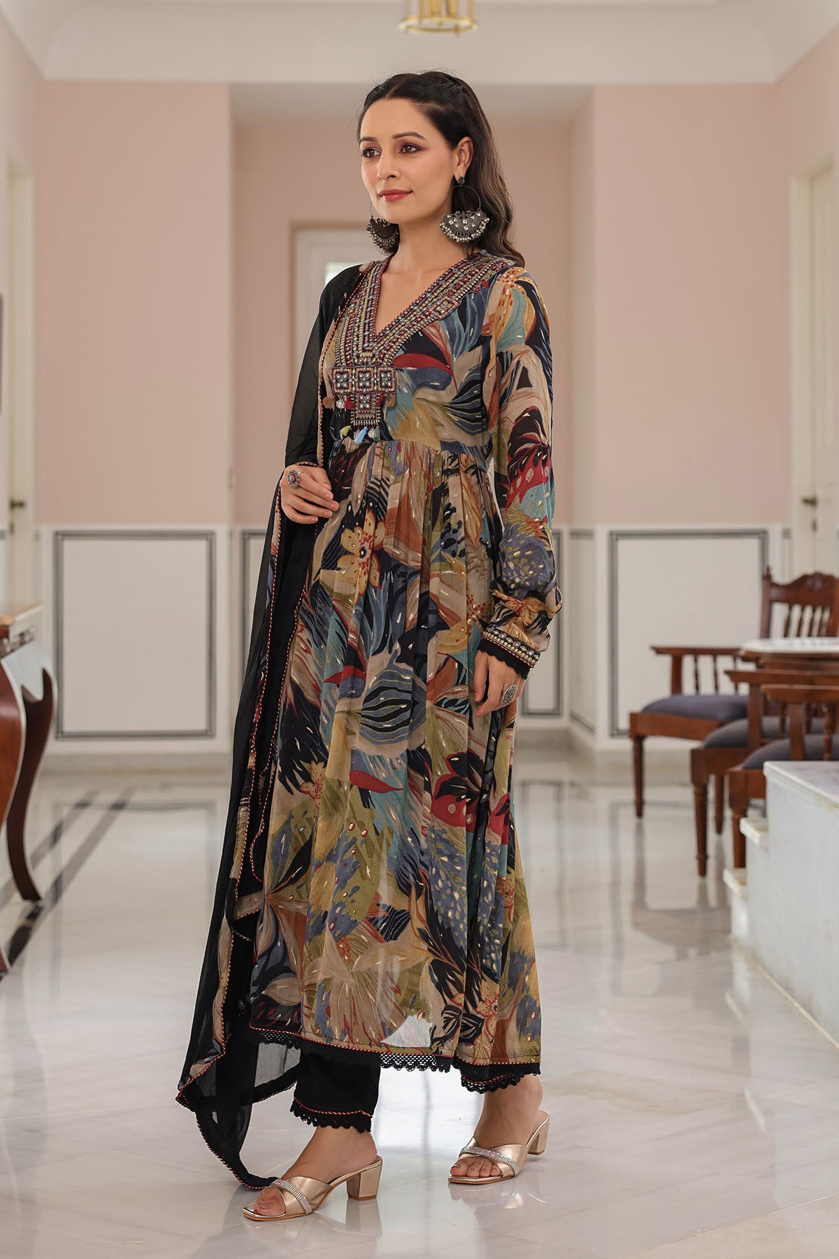 Woman wearing a patterned dress in an indoor setting