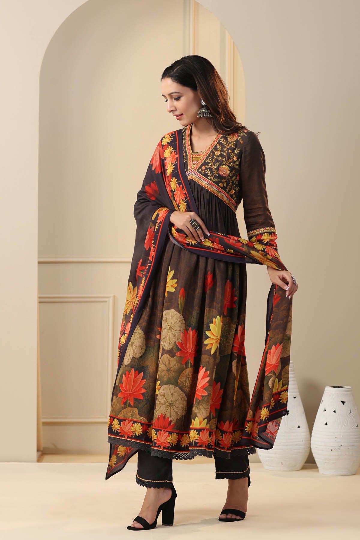 Woman wearing a floral-patterned traditional outfit with a neutral background