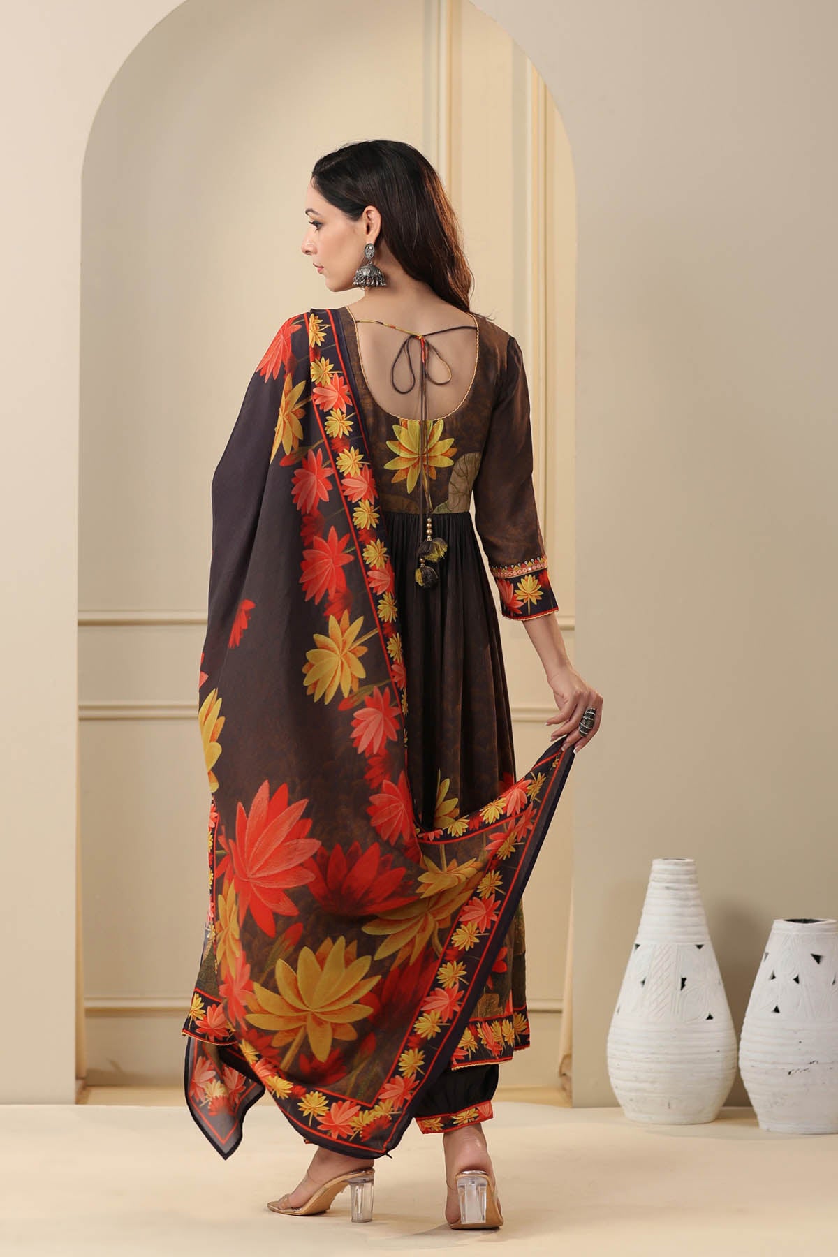 Woman wearing a floral dress with a plain background