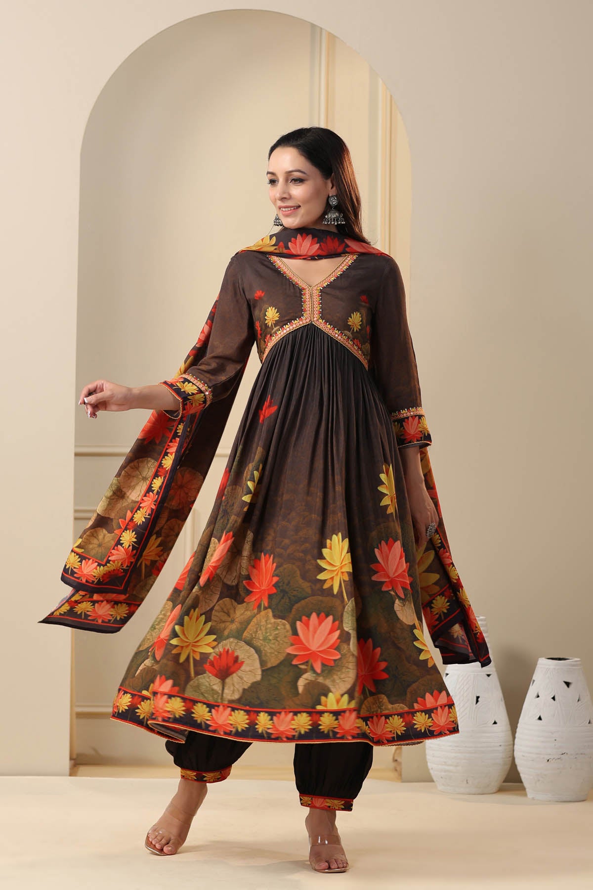 Woman wearing a floral embroidered dress in a minimalistic setting