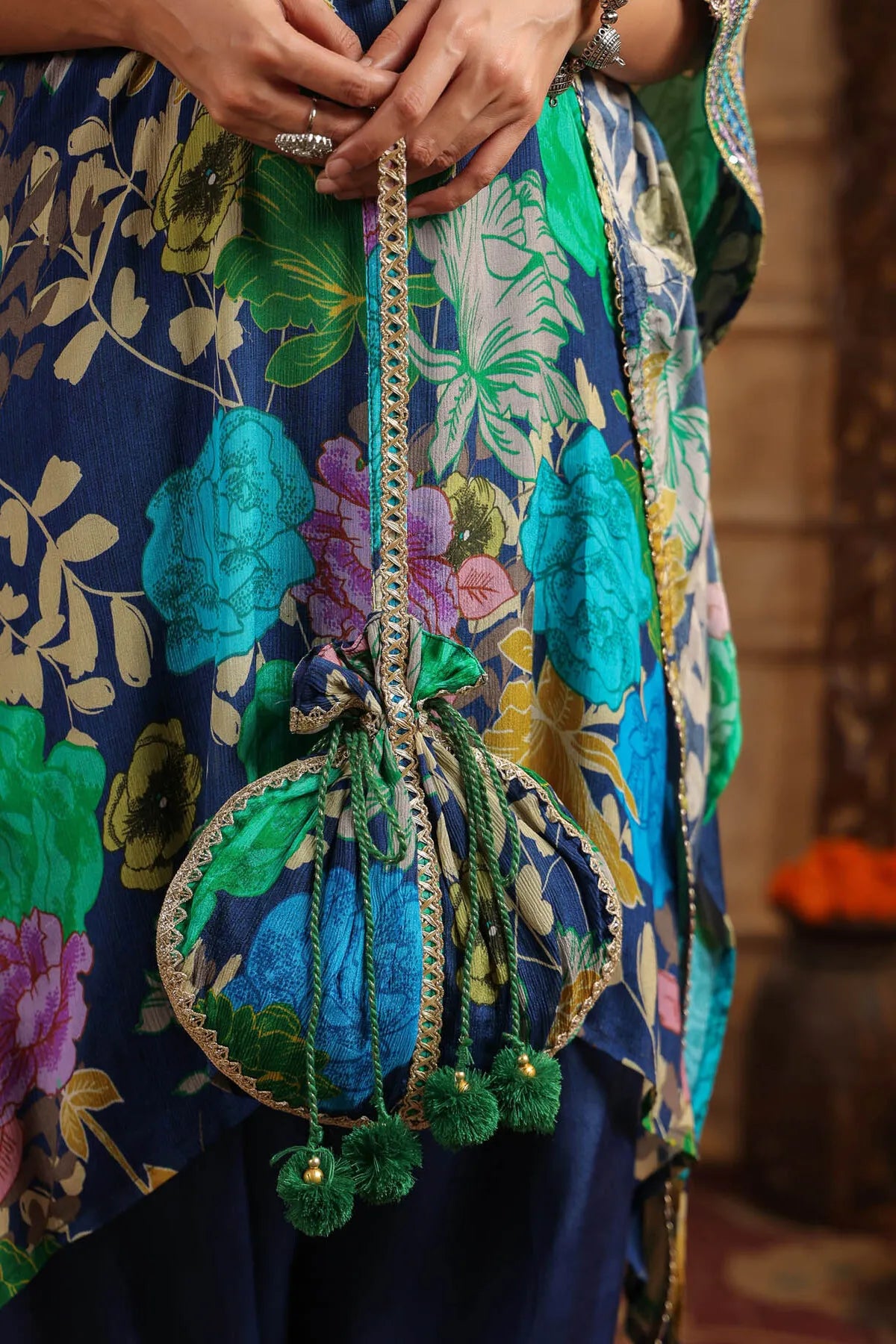 Close-up of a colorful traditional outfit with a decorative bag.