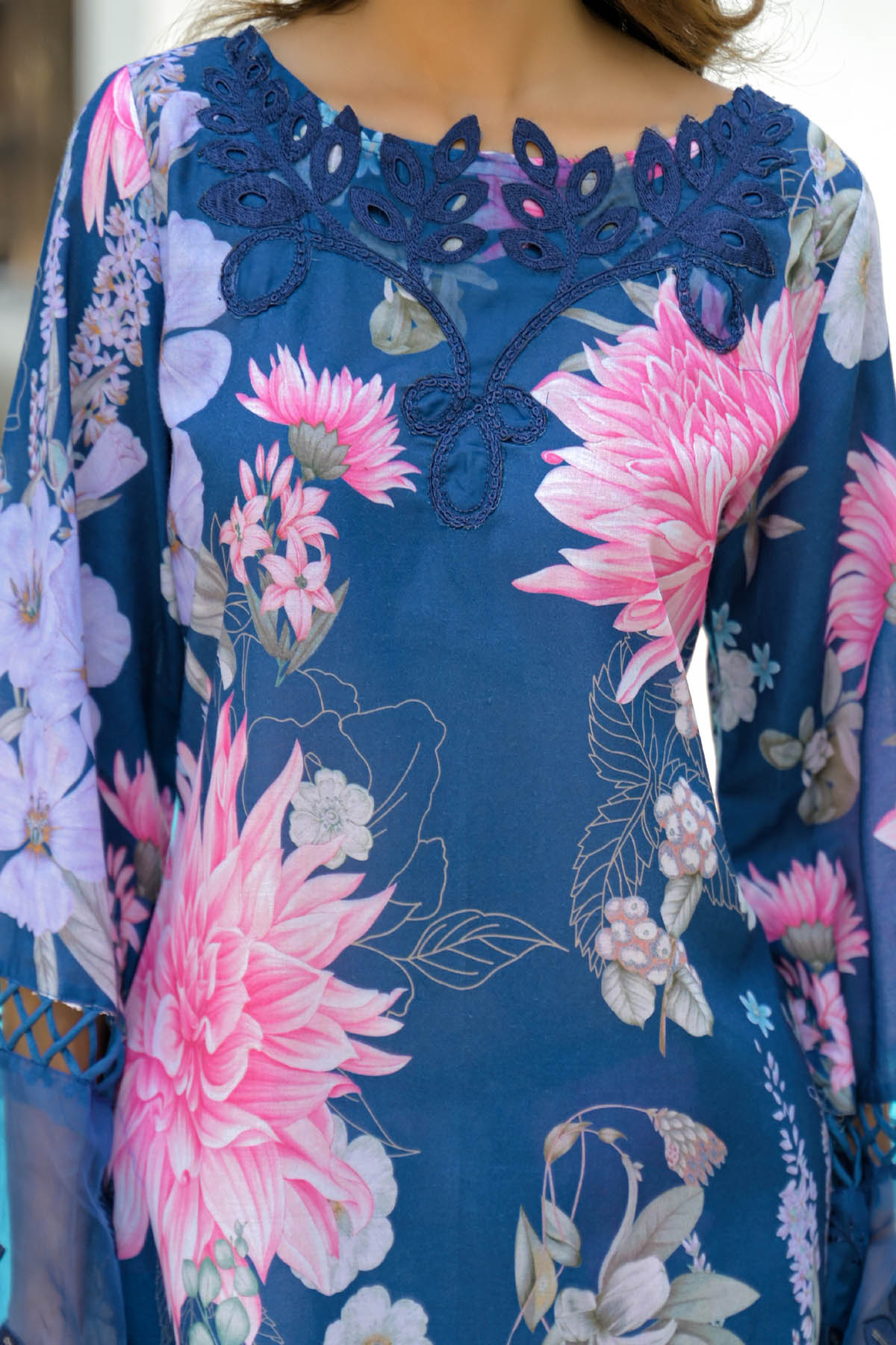 Floral patterned garment with pink and white flowers on a blue background