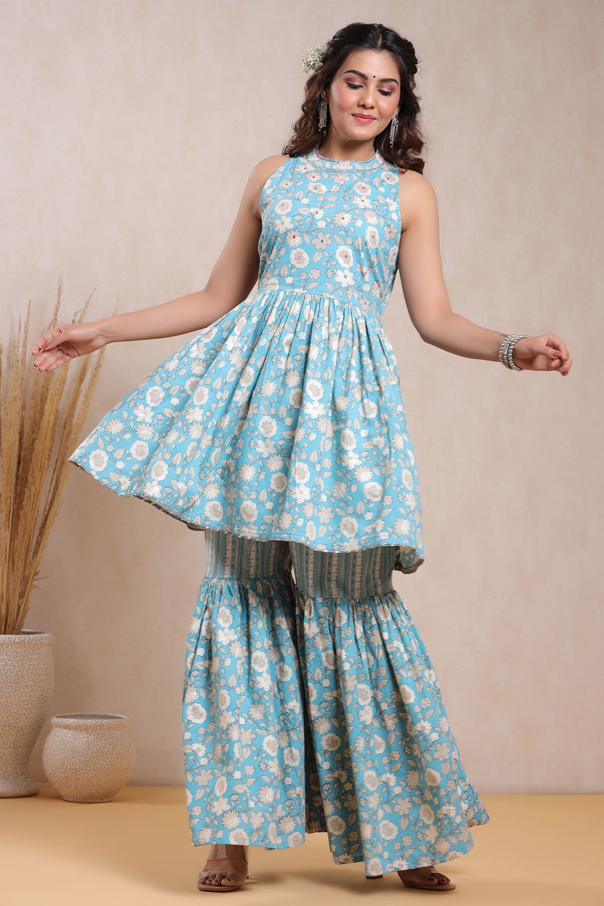 Woman wearing a blue floral dress with a beige background