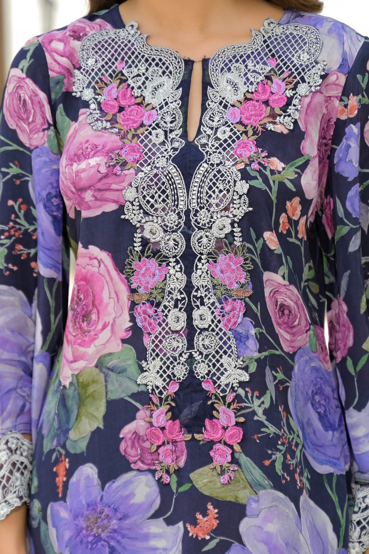 Floral embroidered dress with intricate patterns on a dark background