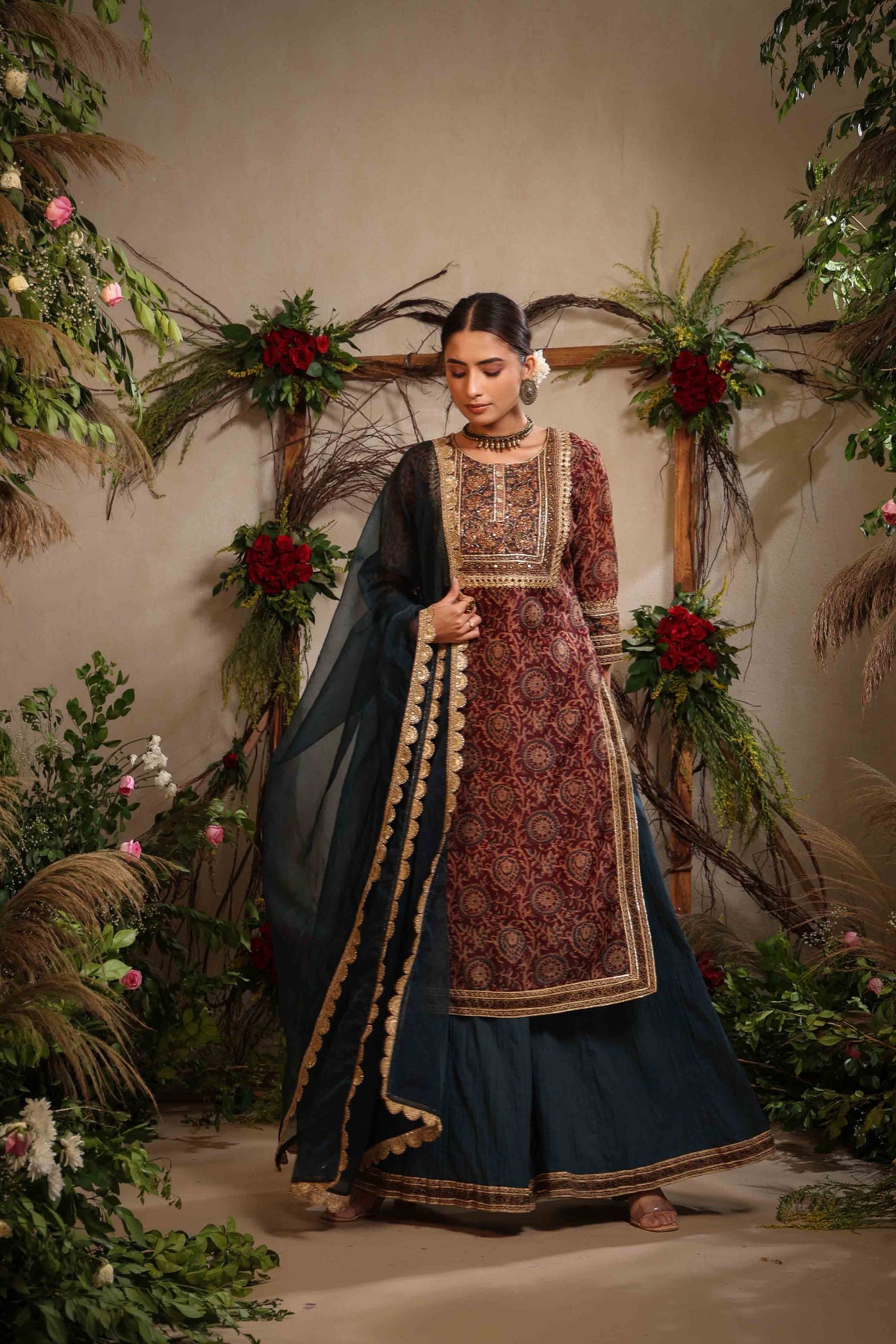 Woman in traditional outfit with floral and decorative background
