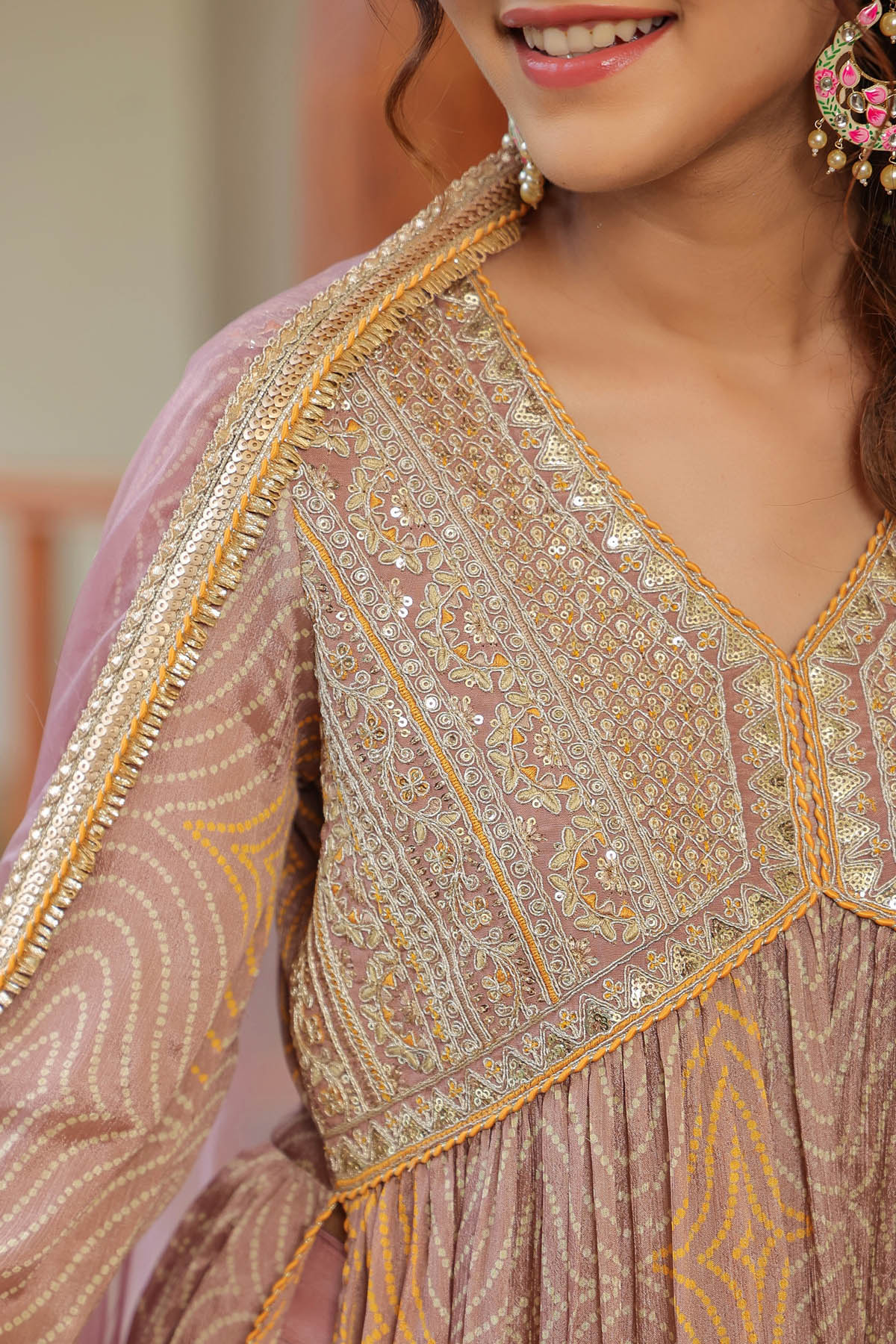 Woman wearing a traditional embroidered outfit with gold detailing