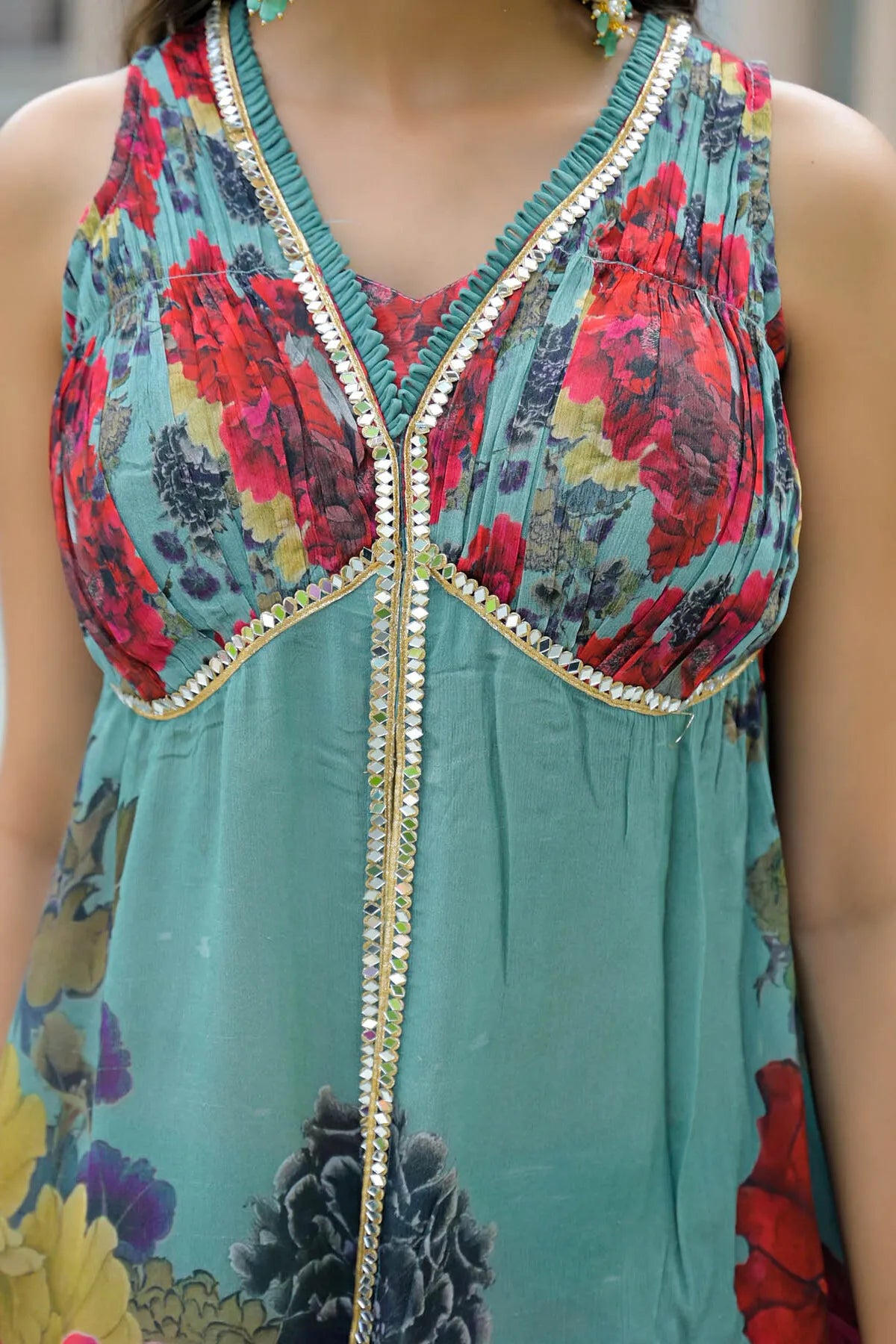 Colorful floral dress with a decorative zipper detail on a blurred background