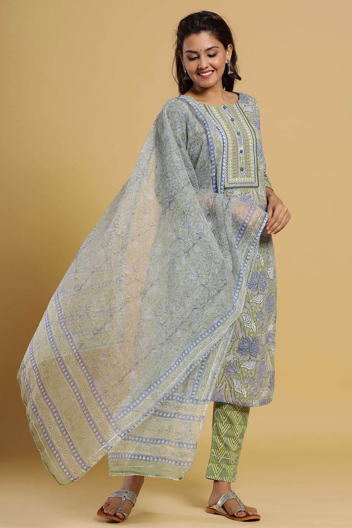 Woman wearing a traditional outfit with a beige background