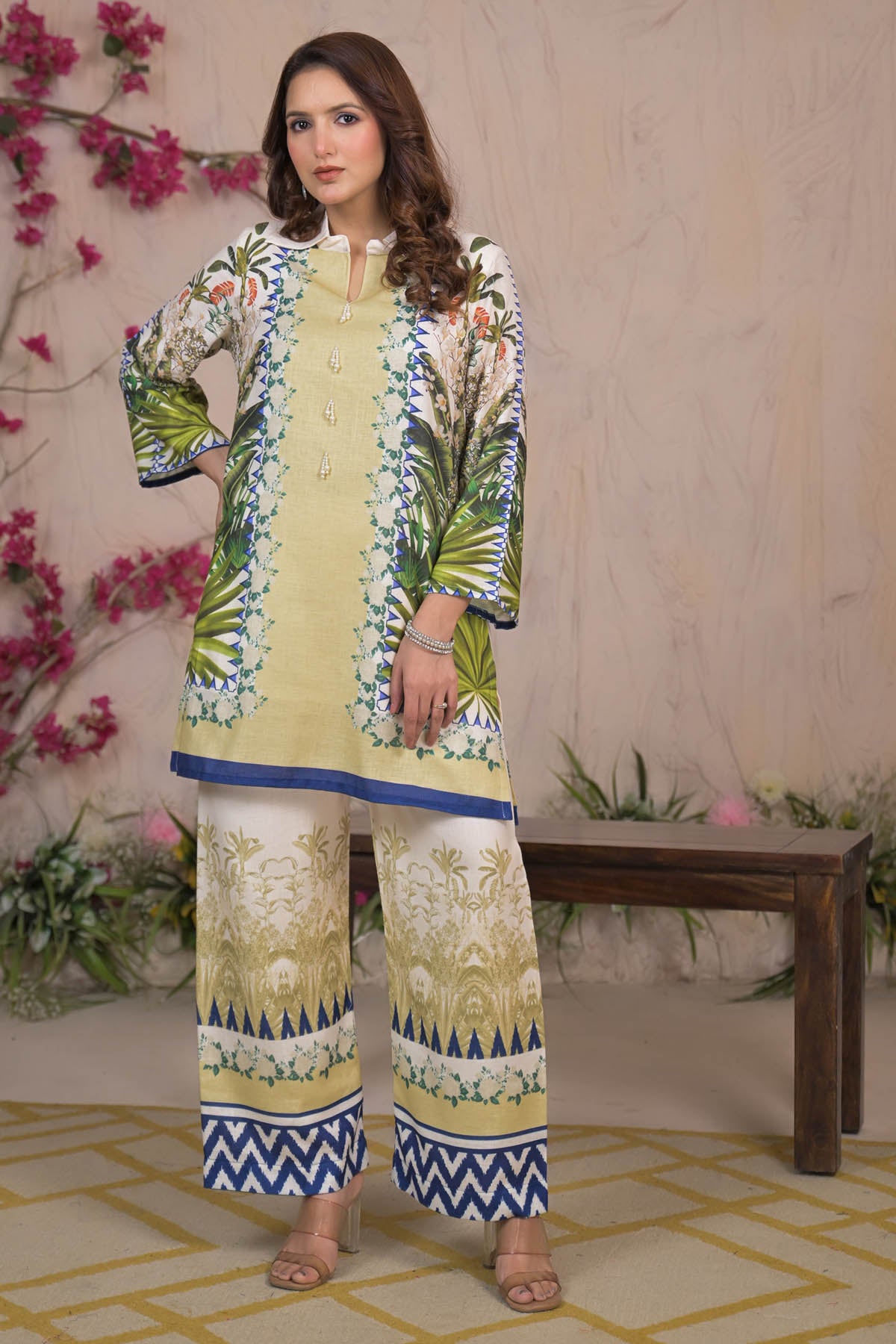 Woman wearing a floral embroidered outfit with a decorative background