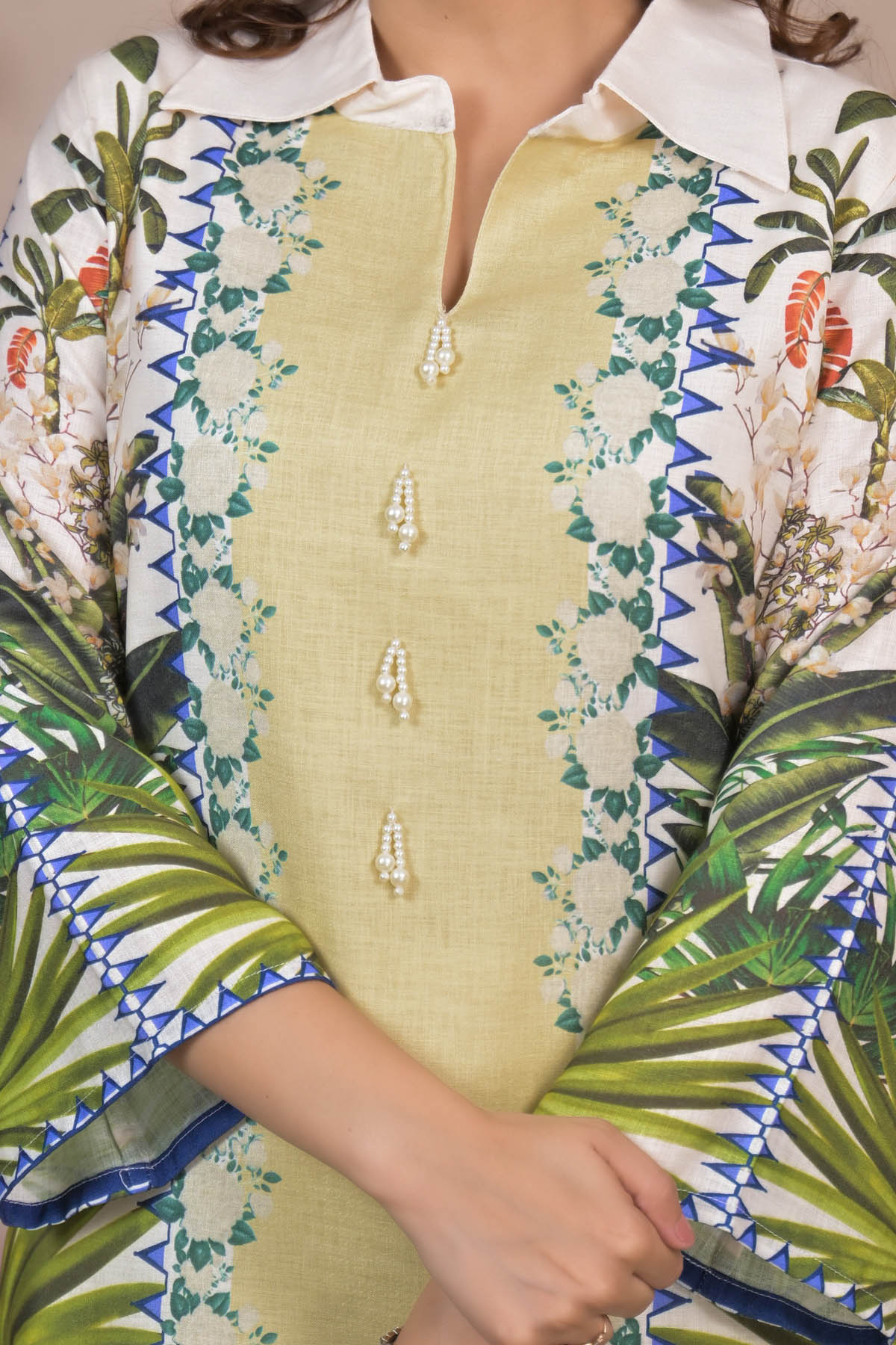 Traditional outfit with floral and geometric patterns on a white background