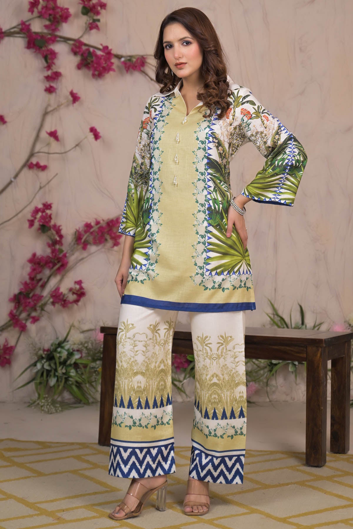 Woman in a floral embroidered outfit with a decorative background