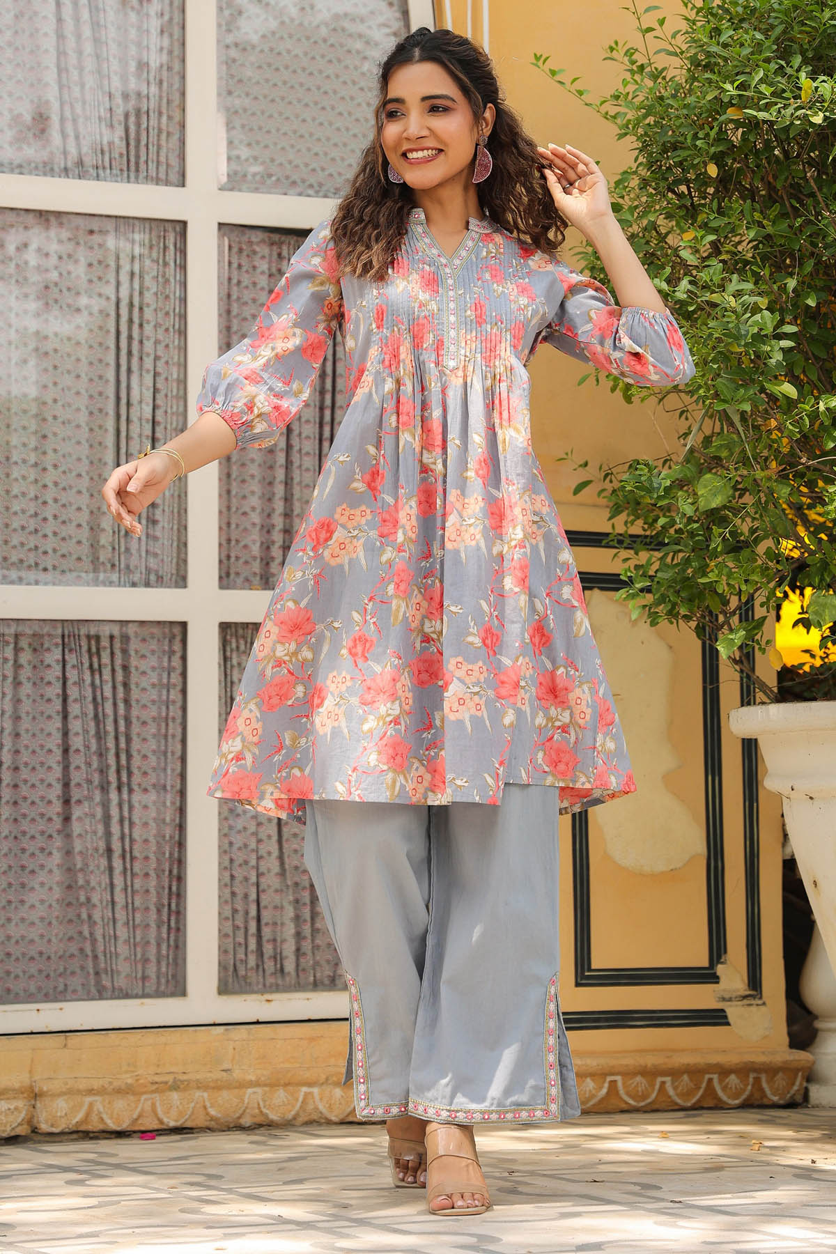 Woman wearing a floral dress with a neutral background