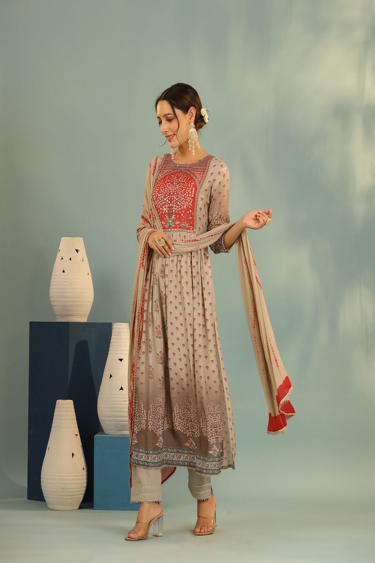 Woman in traditional outfit with a plain background