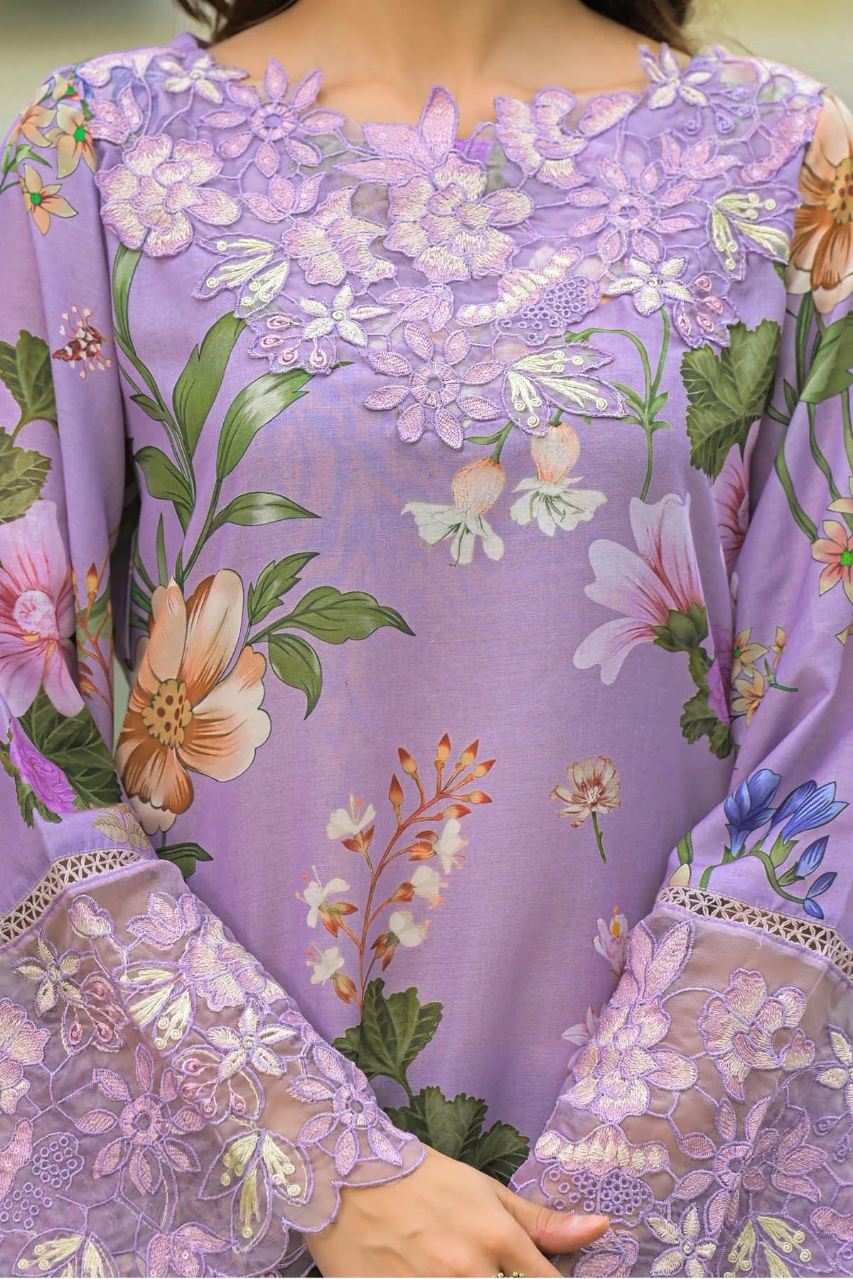 Close-up of a person wearing a floral dress with a purple background