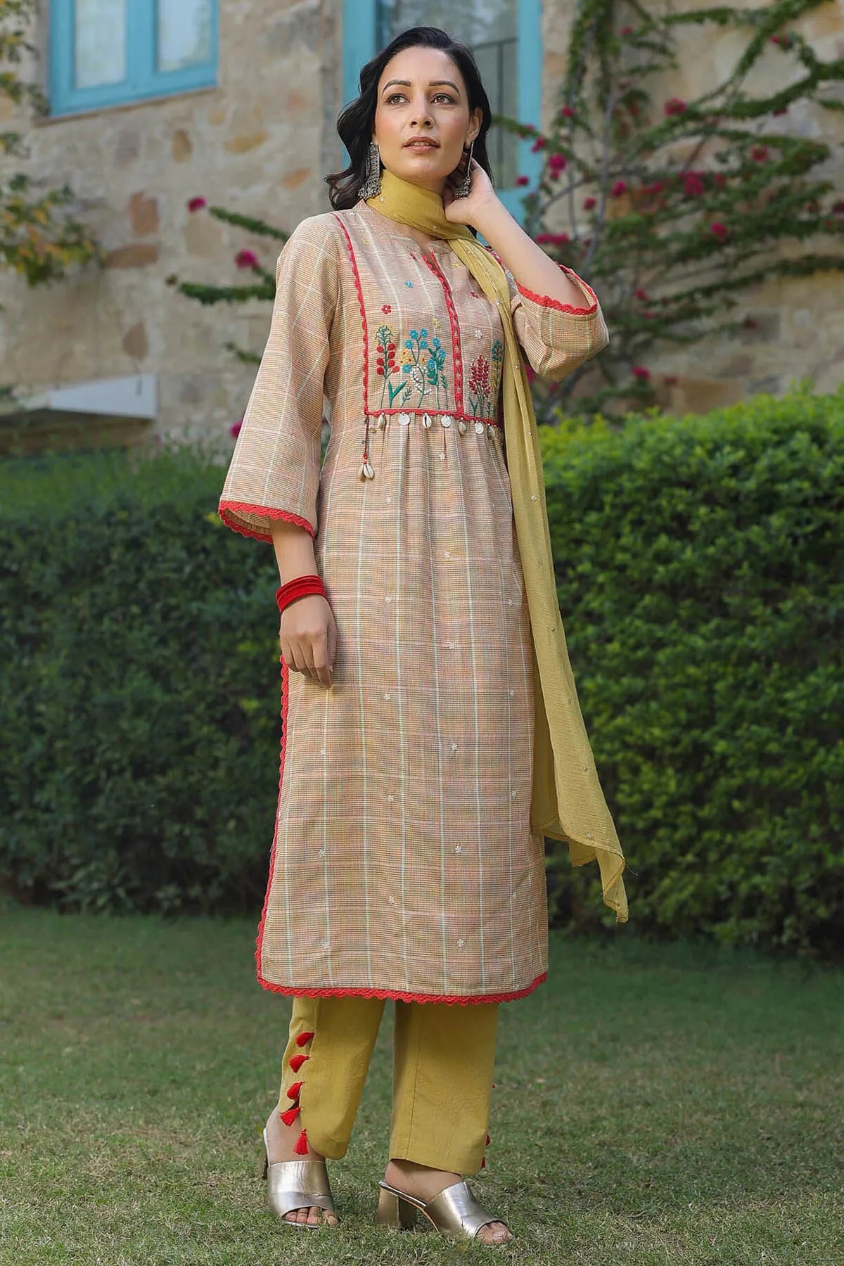 Woman wearing a traditional outfit with embroidery in an outdoor setting