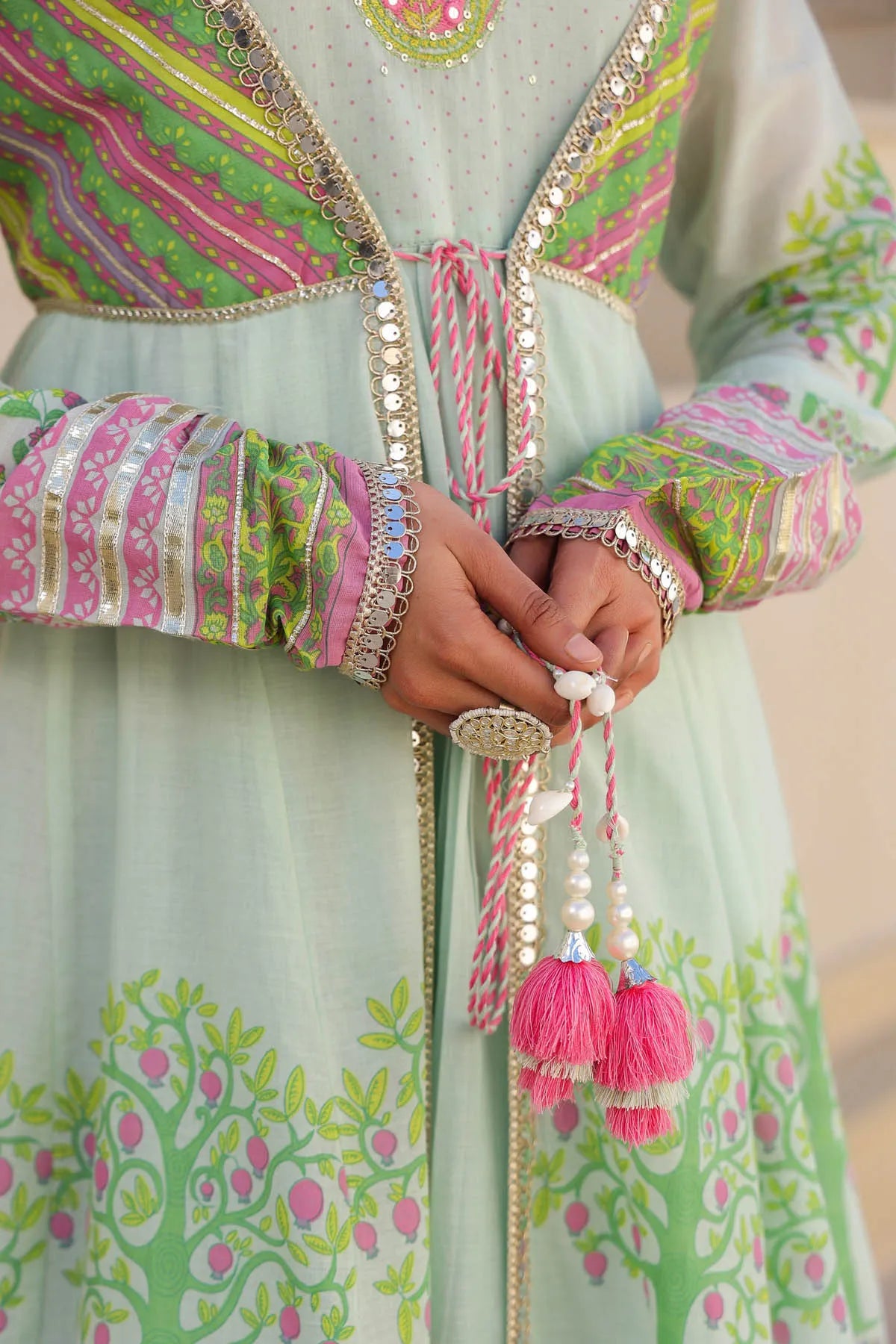 Decorative traditional outfit with colorful patterns and tassels.