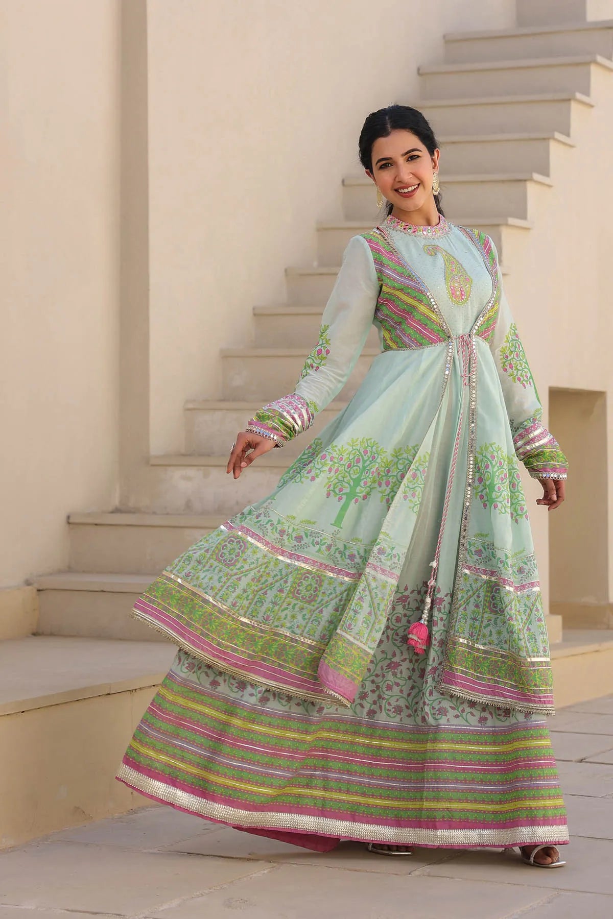 Woman in a traditional outfit standing on a staircase