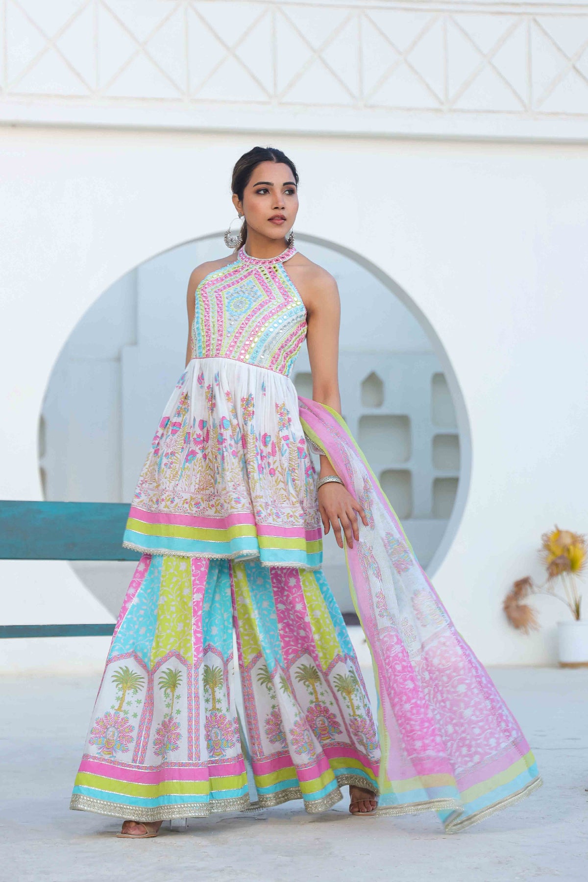 Woman wearing a colorful traditional outfit with a white background