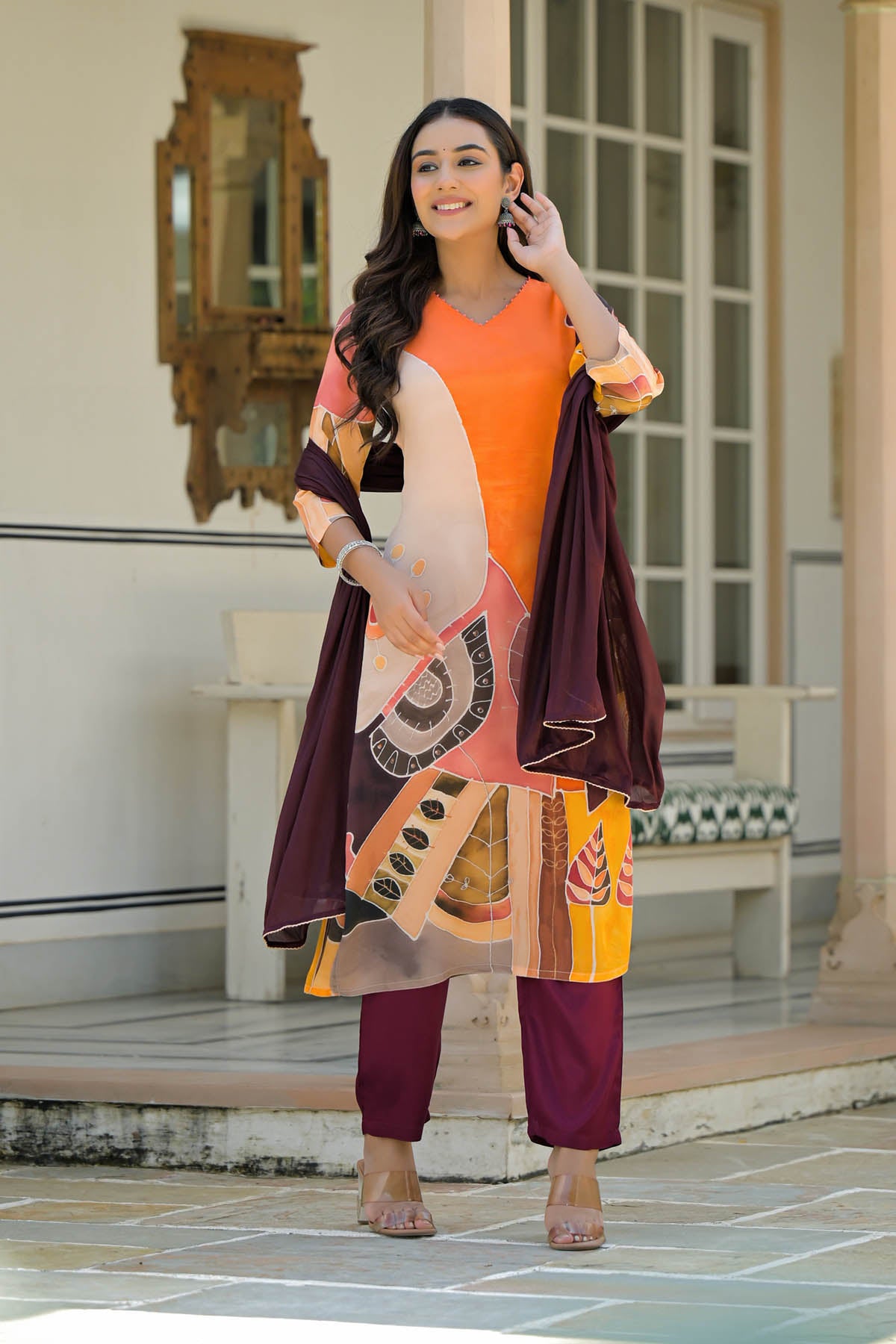 Woman in traditional outfit standing in front of a building entrance