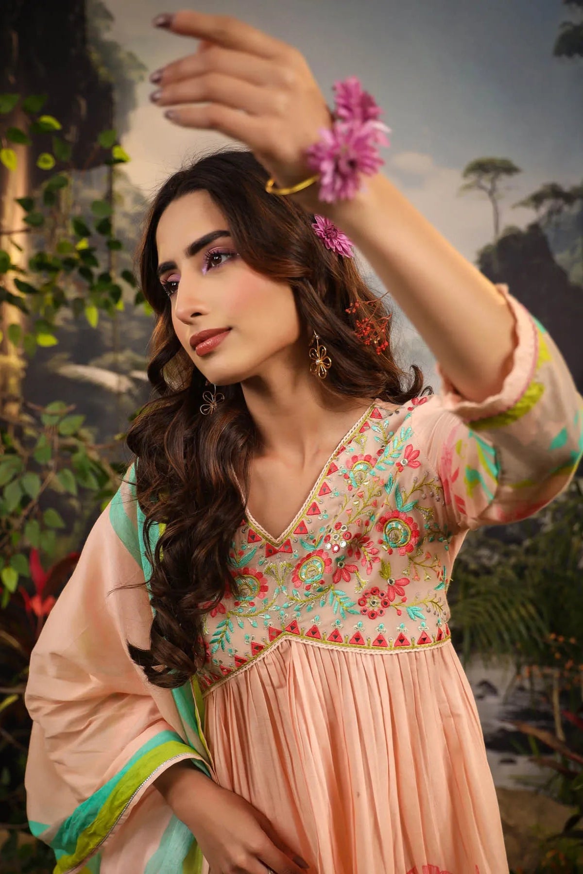 Woman in a floral dress with a nature-themed background