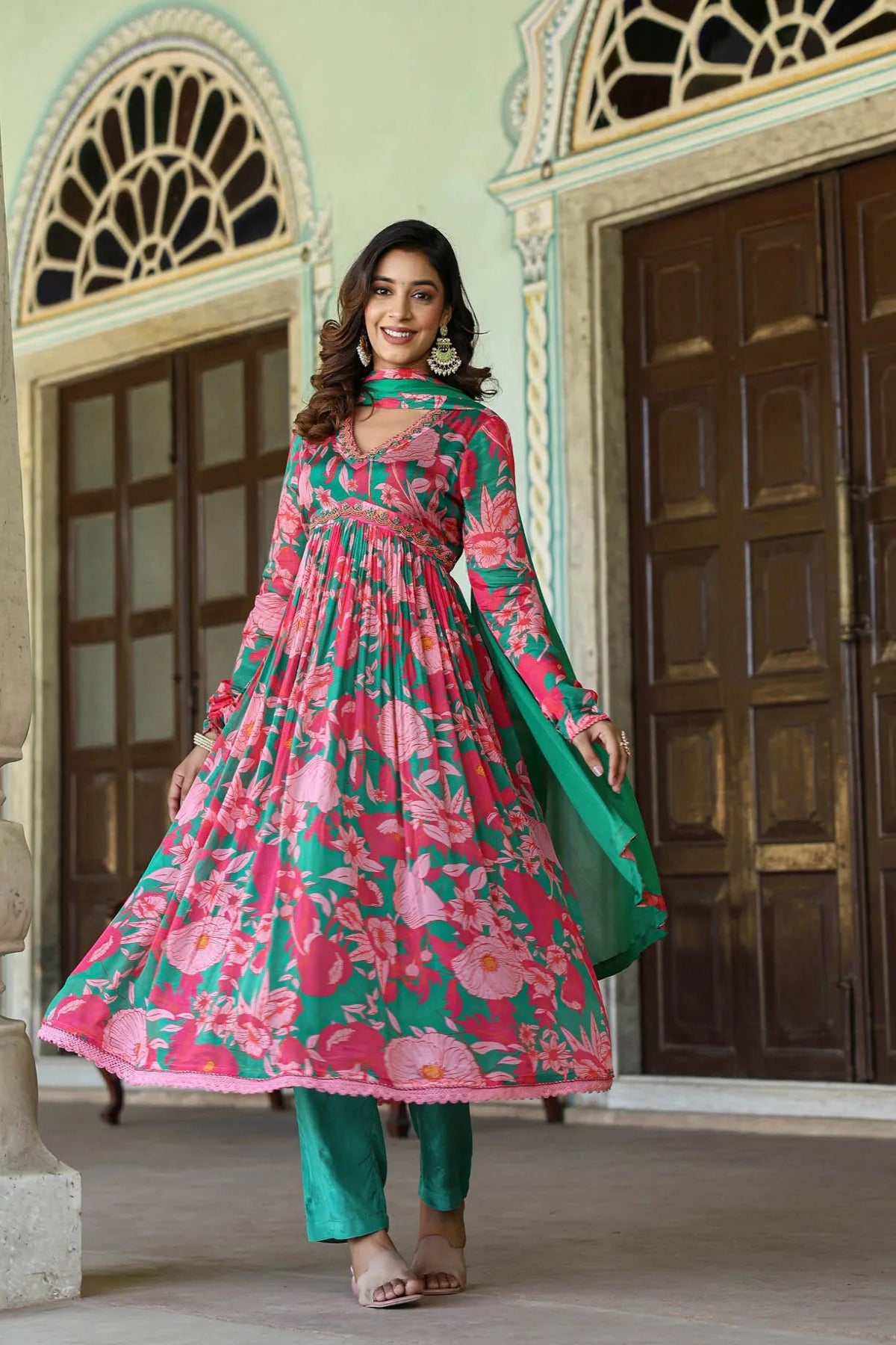 Woman in a floral dress standing in an architectural setting