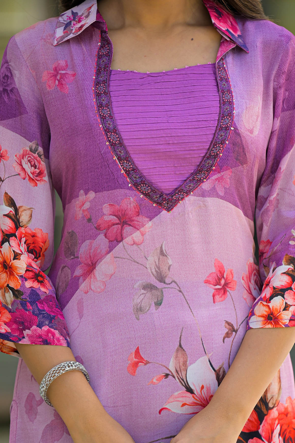 Purple floral dress with a close-up of the neckline and sleeves.