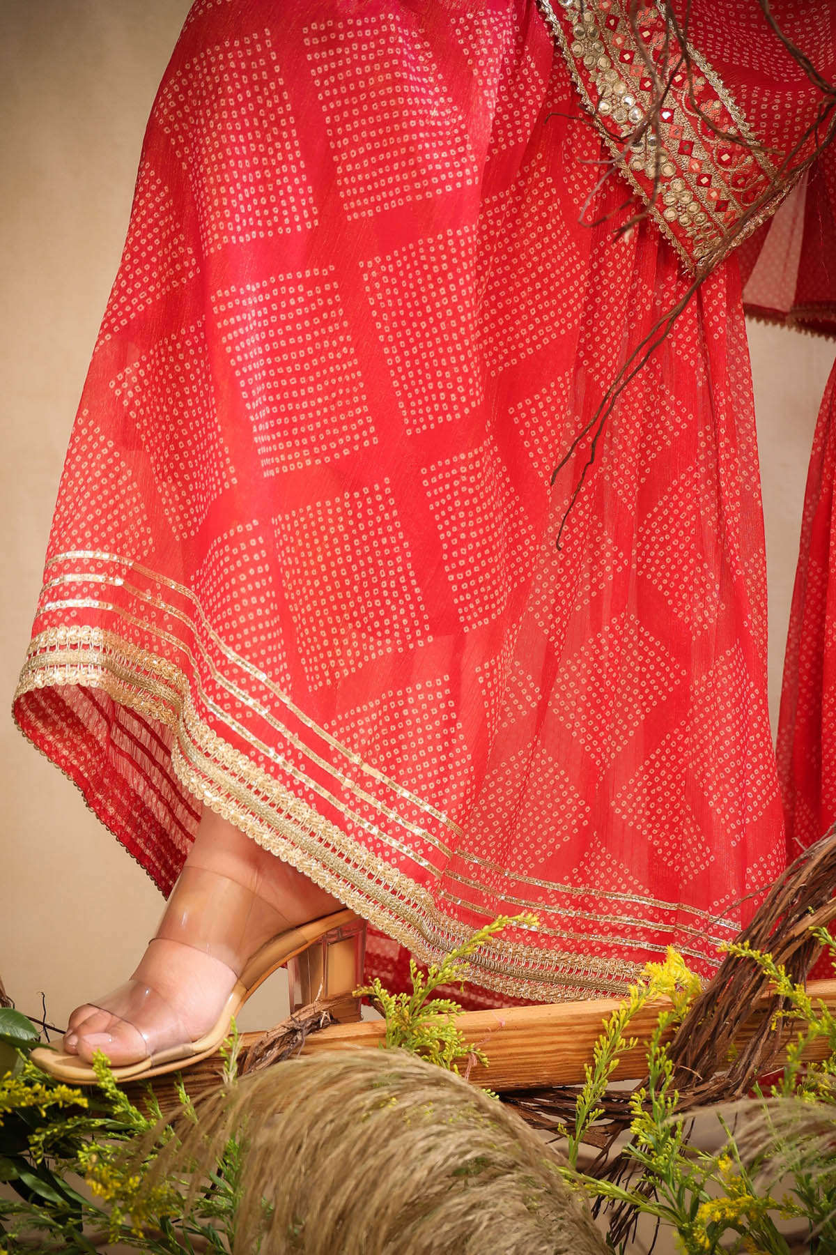 Red patterned fabric with gold trim on a neutral background