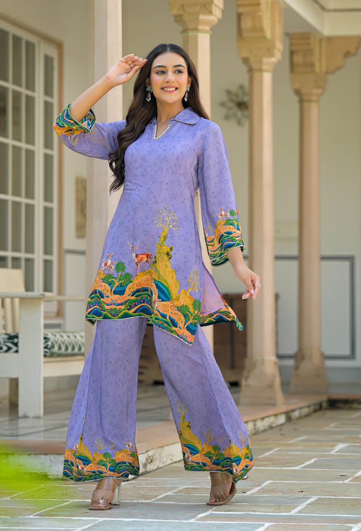 Woman wearing a purple traditional outfit with colorful patterns in an outdoor setting.