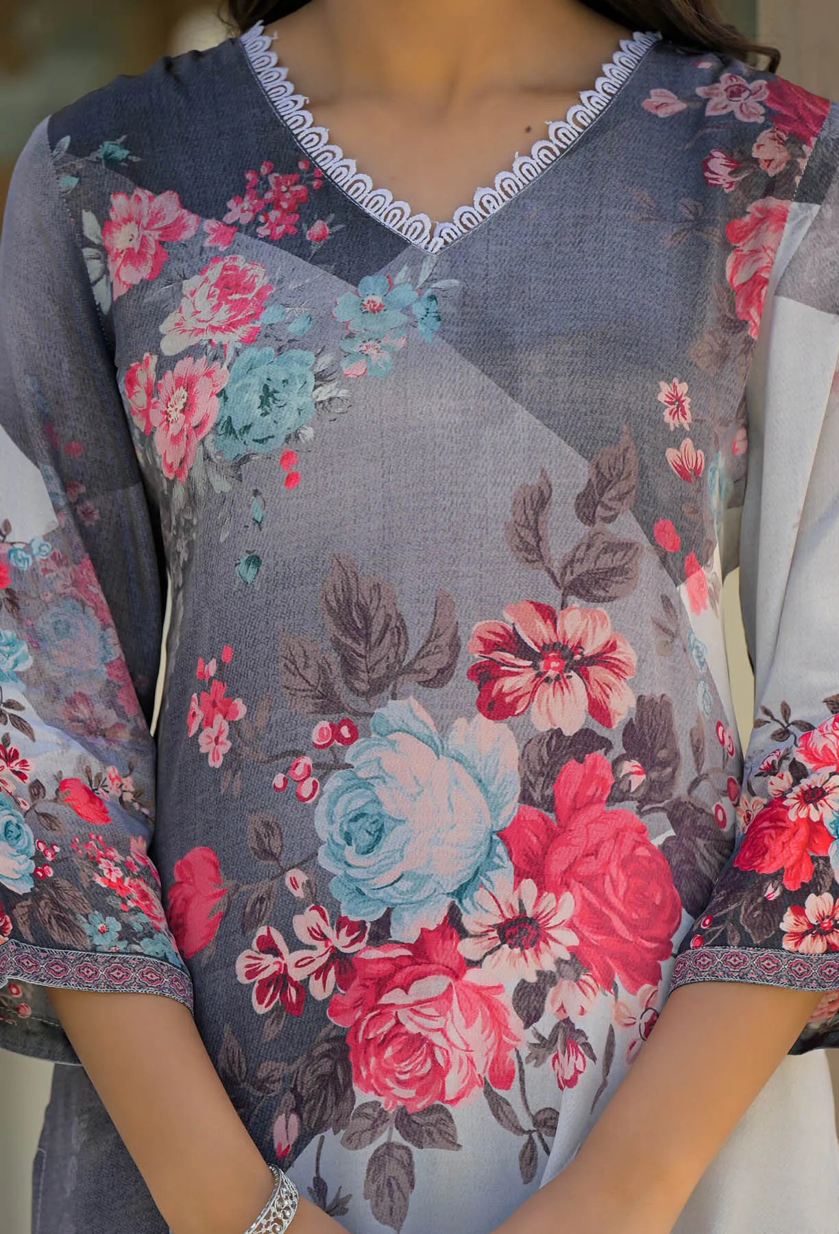Floral patterned garment with a focus on the neckline and sleeves.
