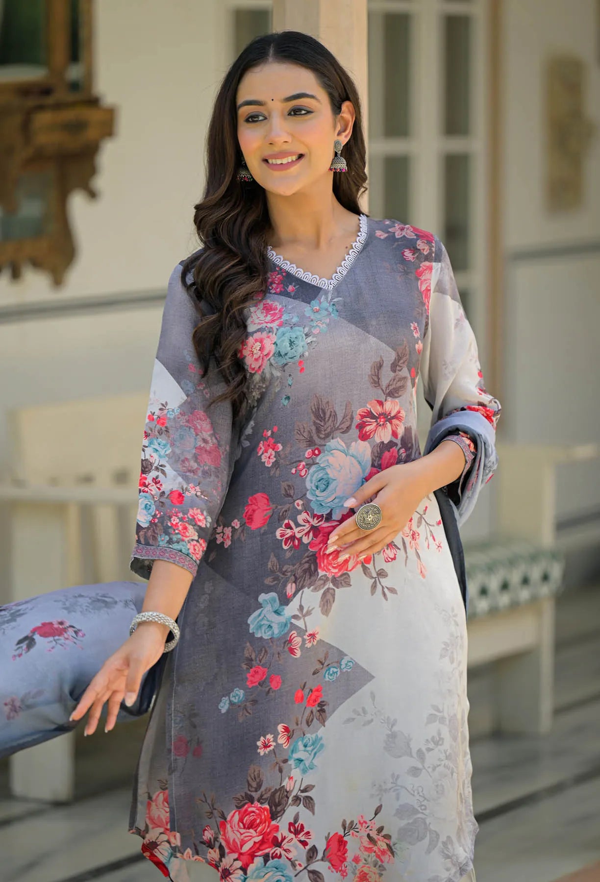 Woman wearing a floral dress with a blurred indoor background