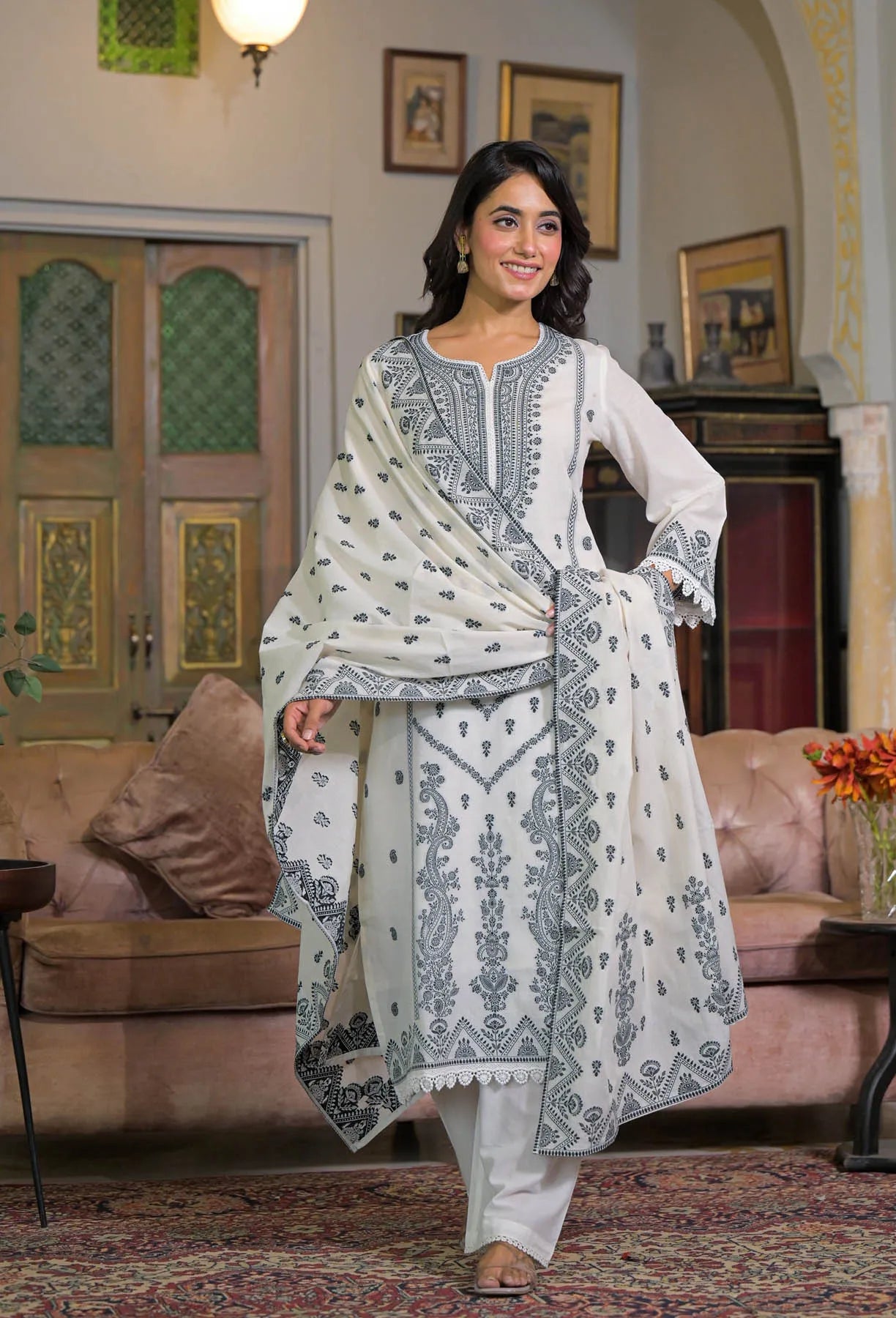 Woman in a traditional outfit standing in a living room.