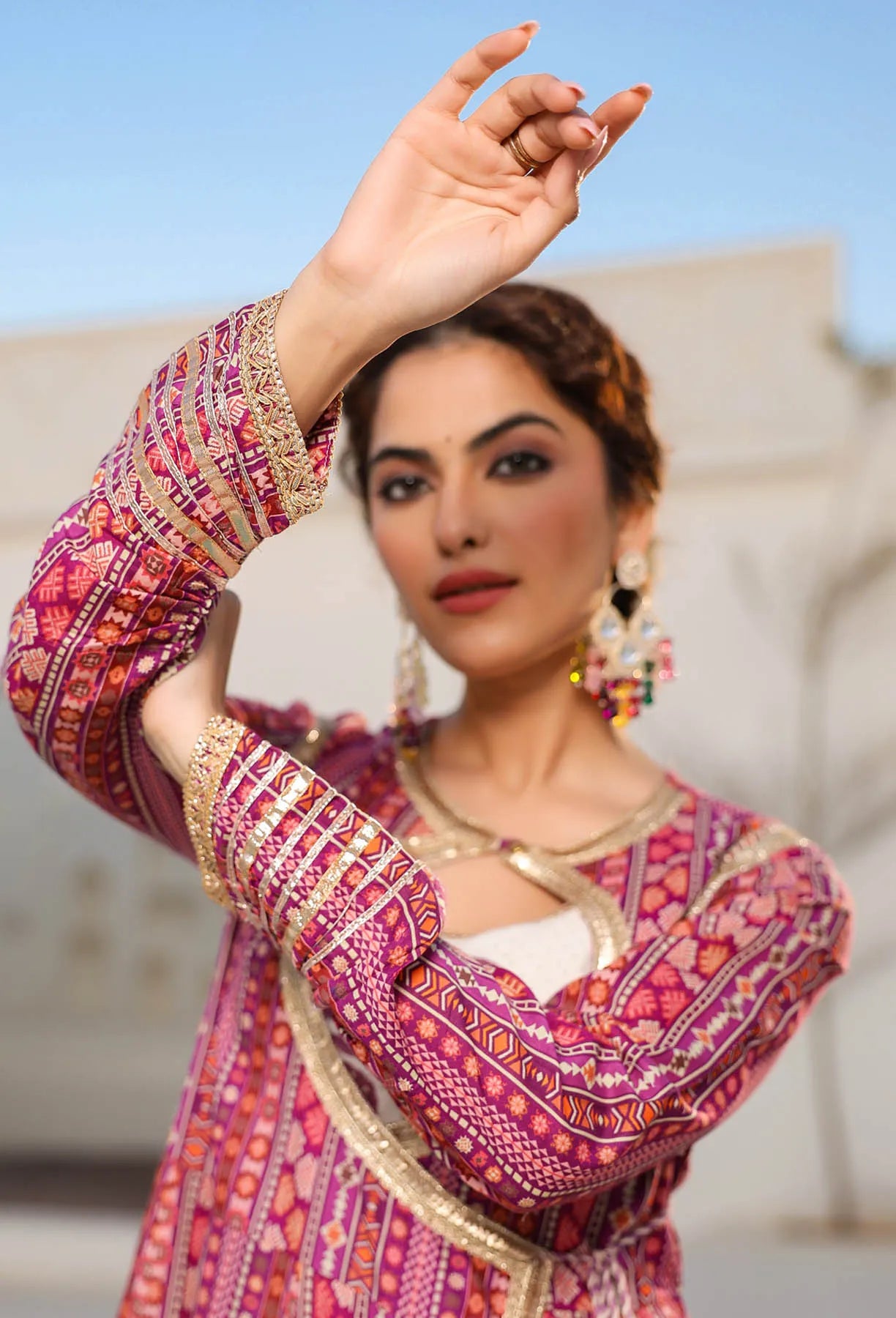 Woman in a colorful traditional outfit with a blurred background