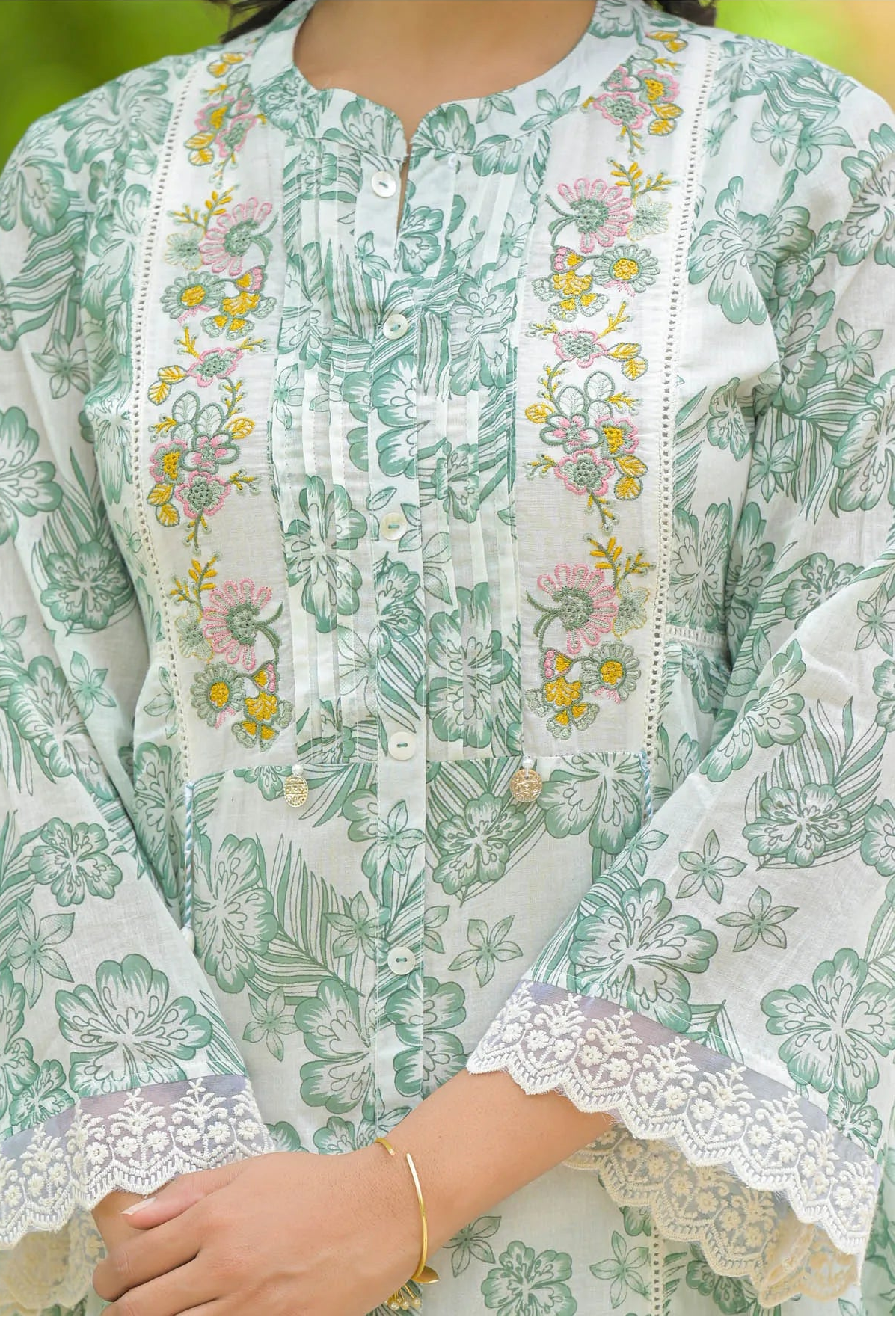 Floral embroidered kurta with lace details on a light green background