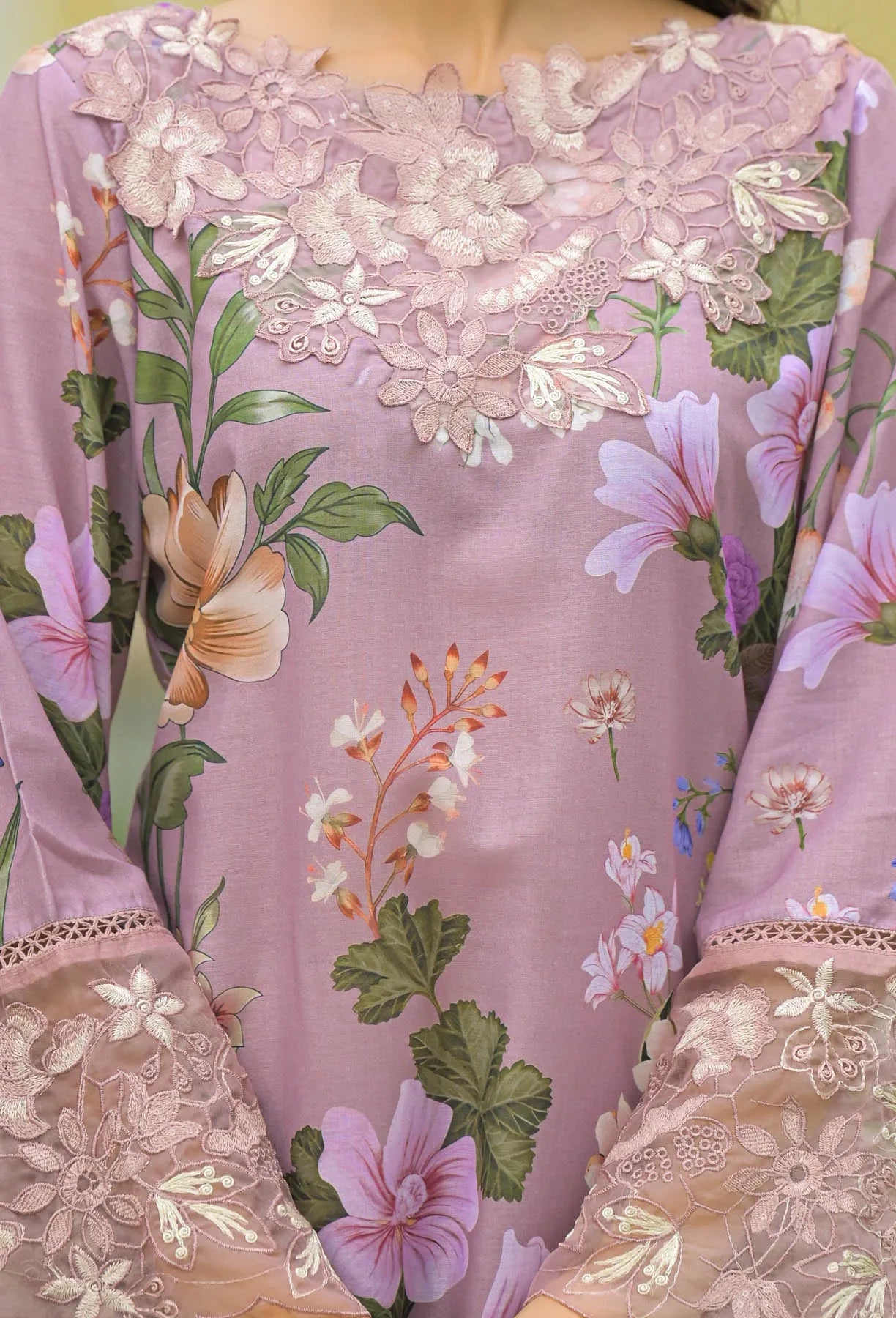 Floral embroidered dress with a soft pink background