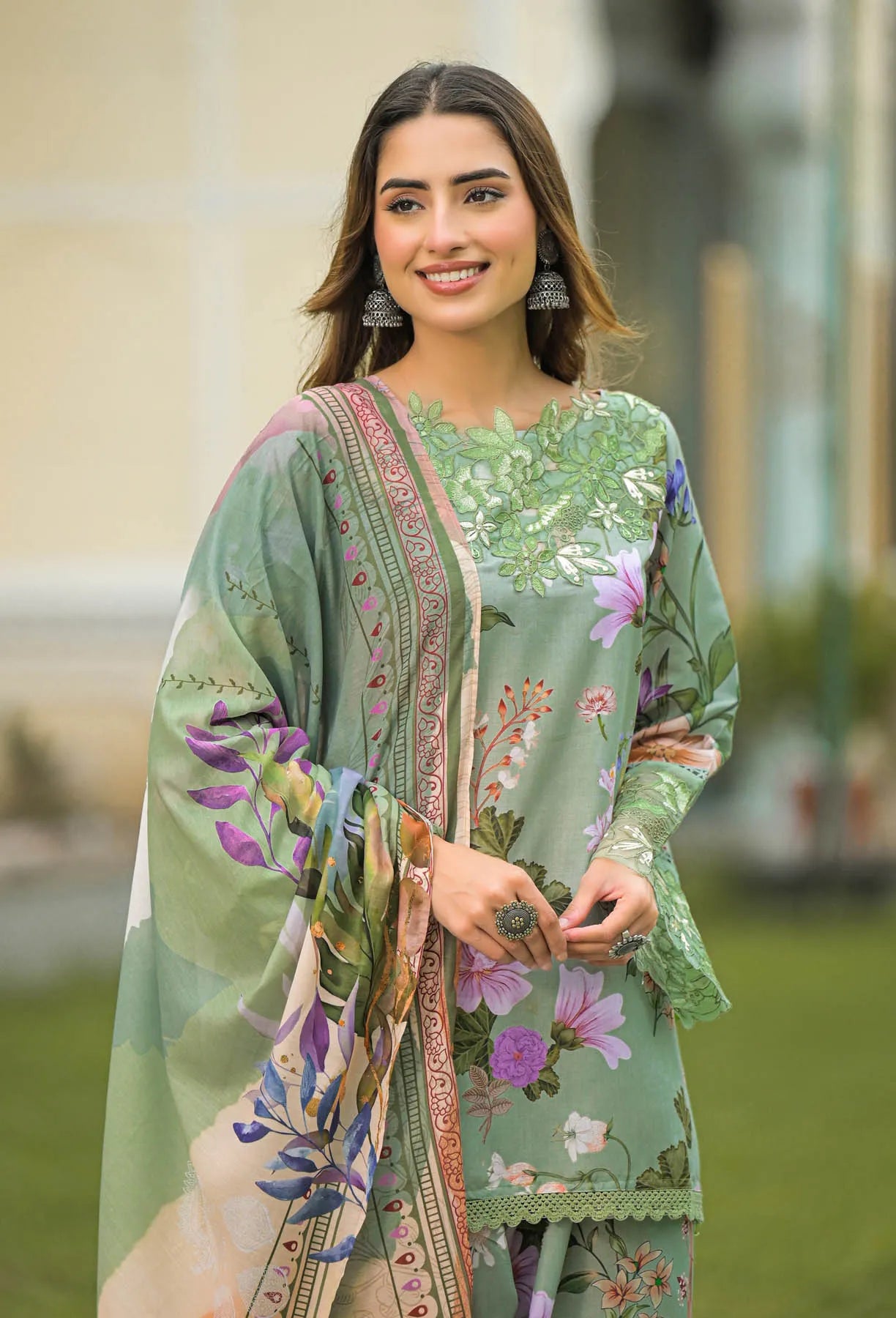 Woman wearing a floral dress with a blurred outdoor background