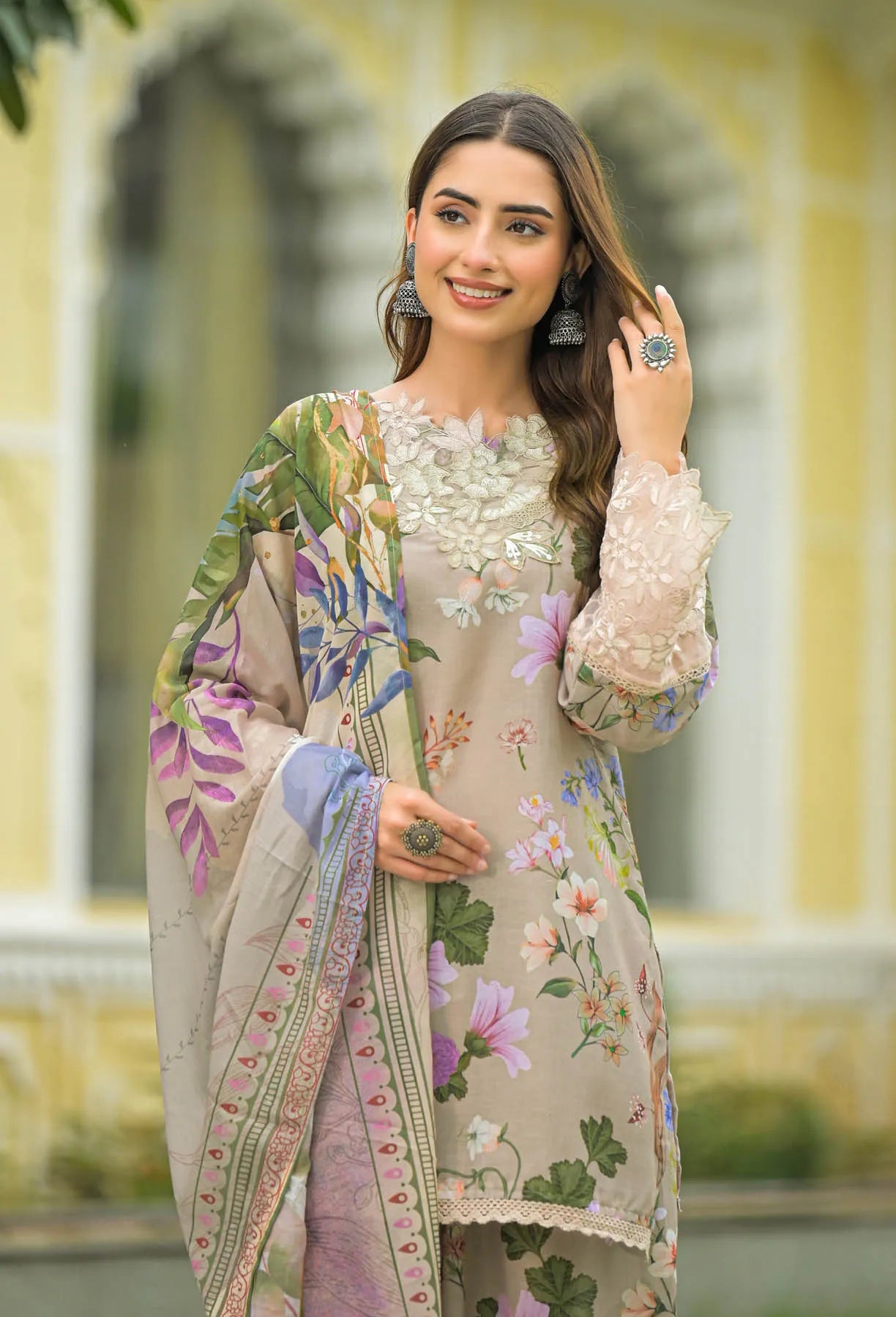 Woman wearing a floral outfit with a matching shawl in an outdoor setting
