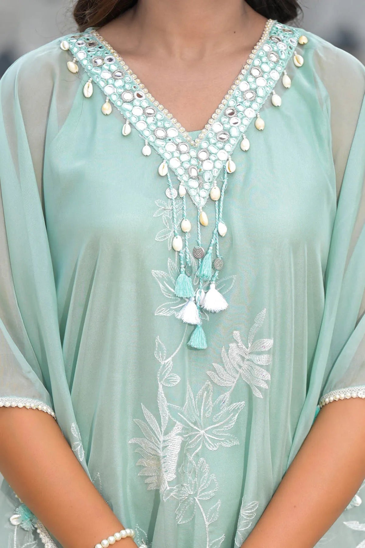 Light blue dress with intricate beadwork and embroidery