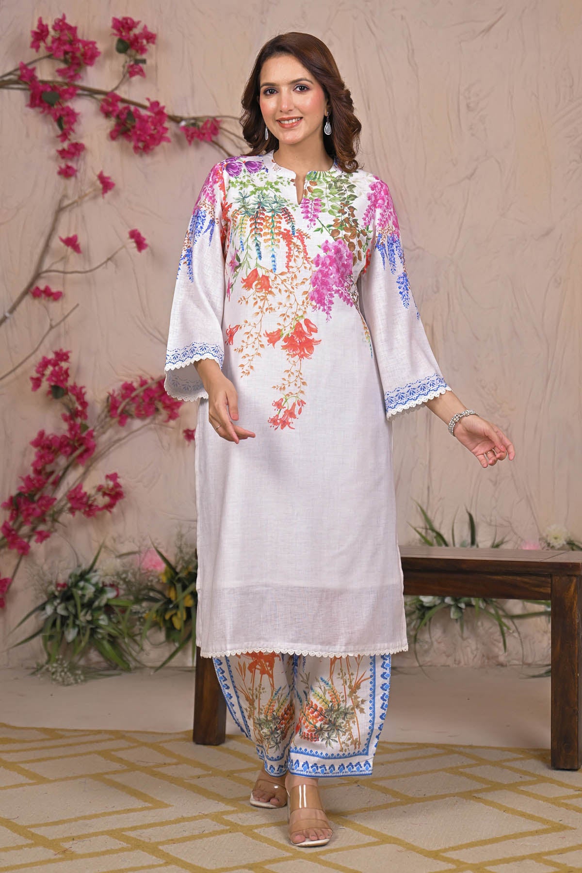 Woman wearing a floral embroidered outfit with a decorative background