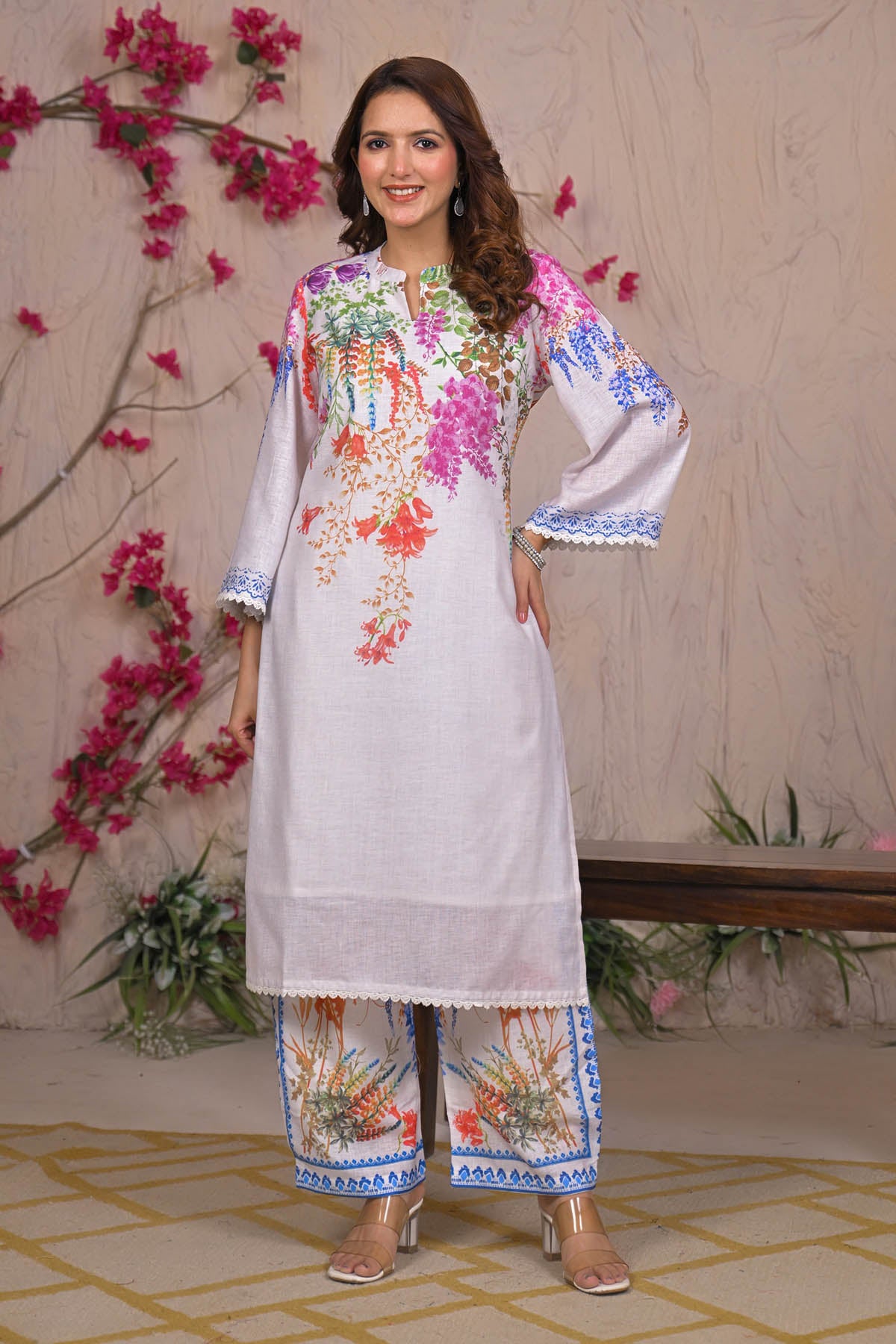 Woman wearing a floral embroidered outfit with a decorative background