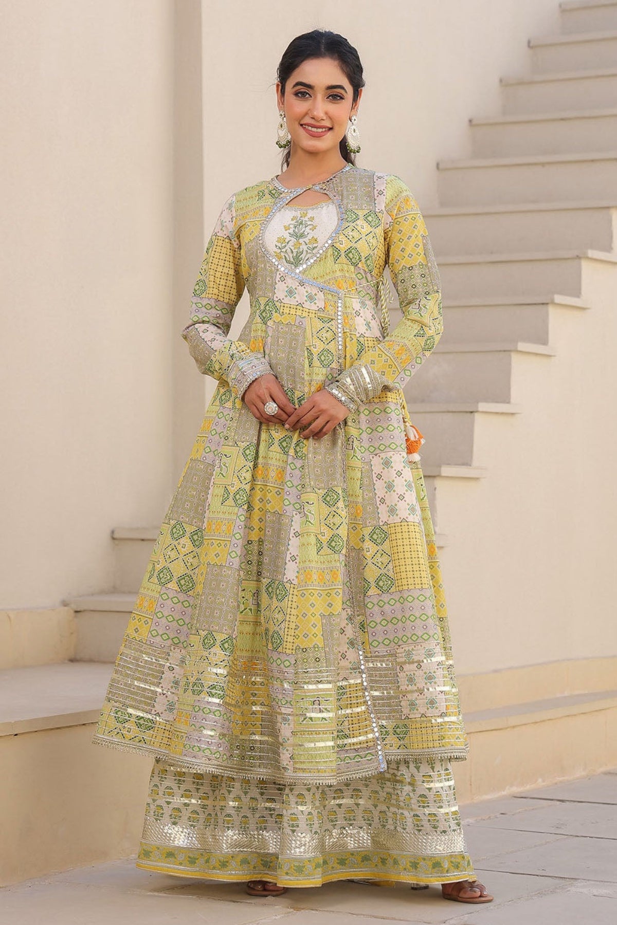 Woman in a traditional outfit standing on a staircase
