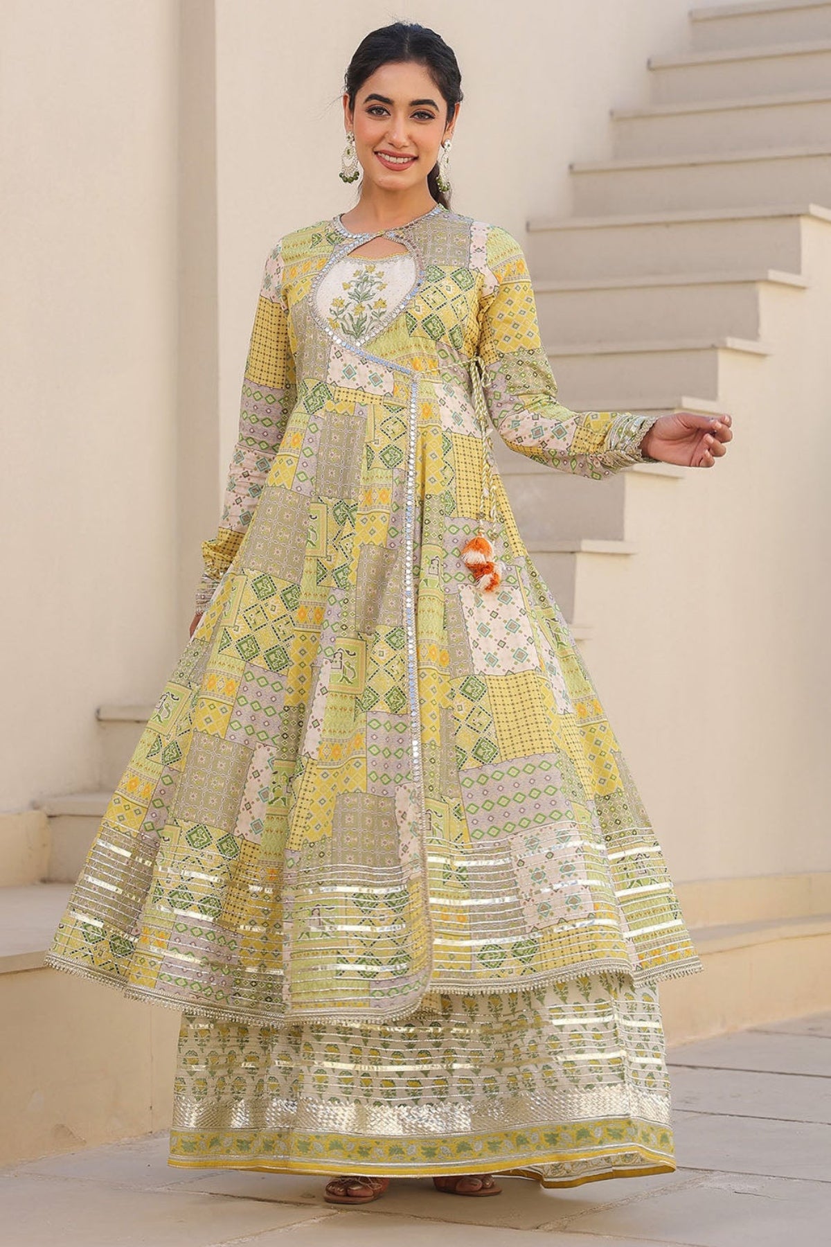 Woman in a traditional outfit standing on a staircase