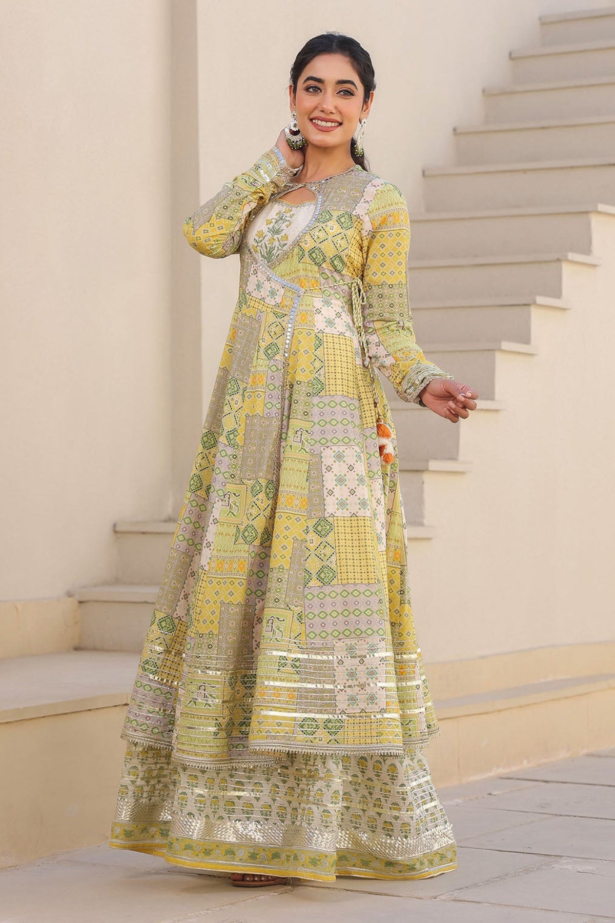 Woman in a traditional outfit standing on a staircase