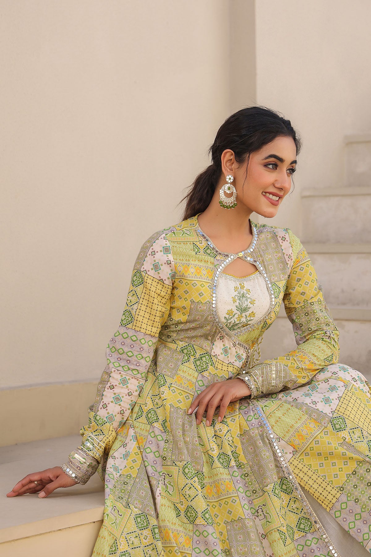 Woman wearing a traditional outfit with floral patterns indoors.