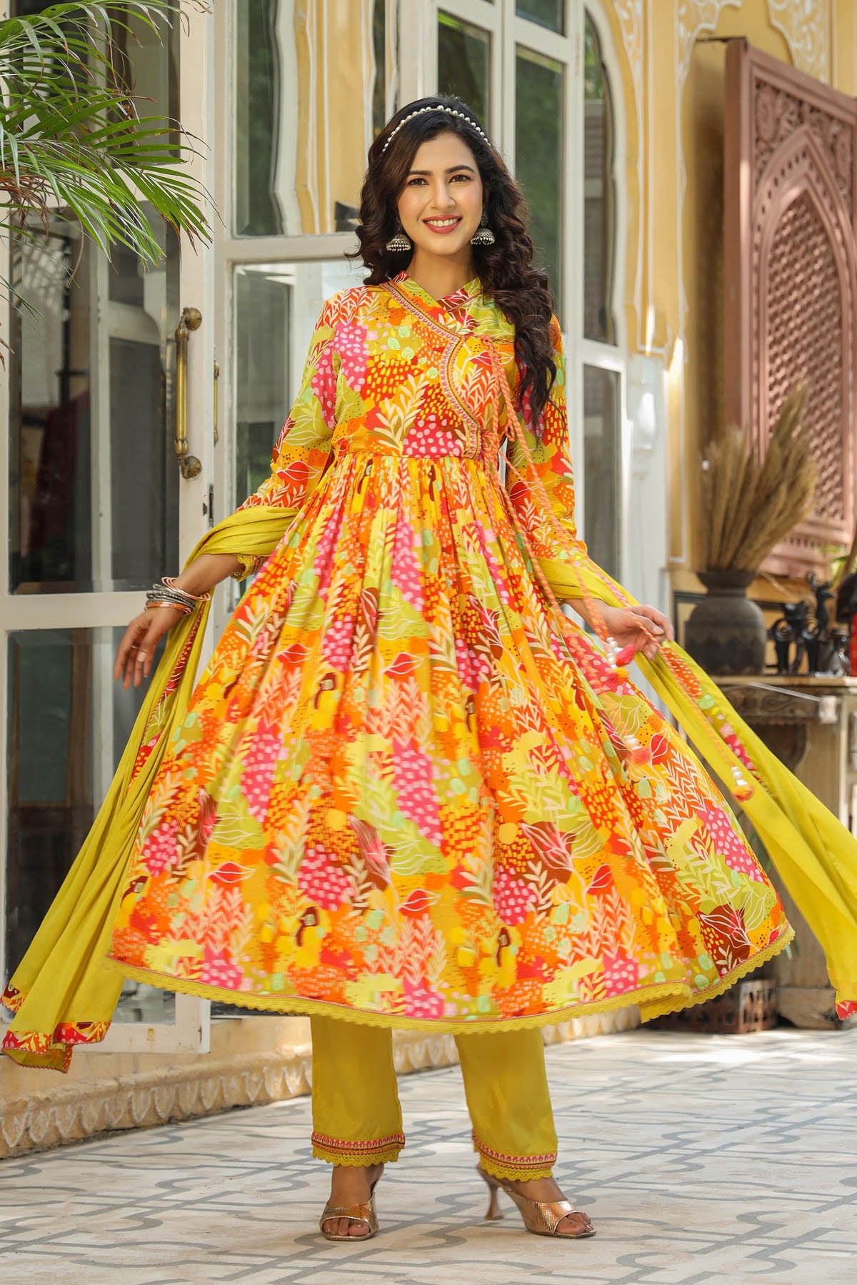 Woman in a colorful traditional outfit standing outdoors.