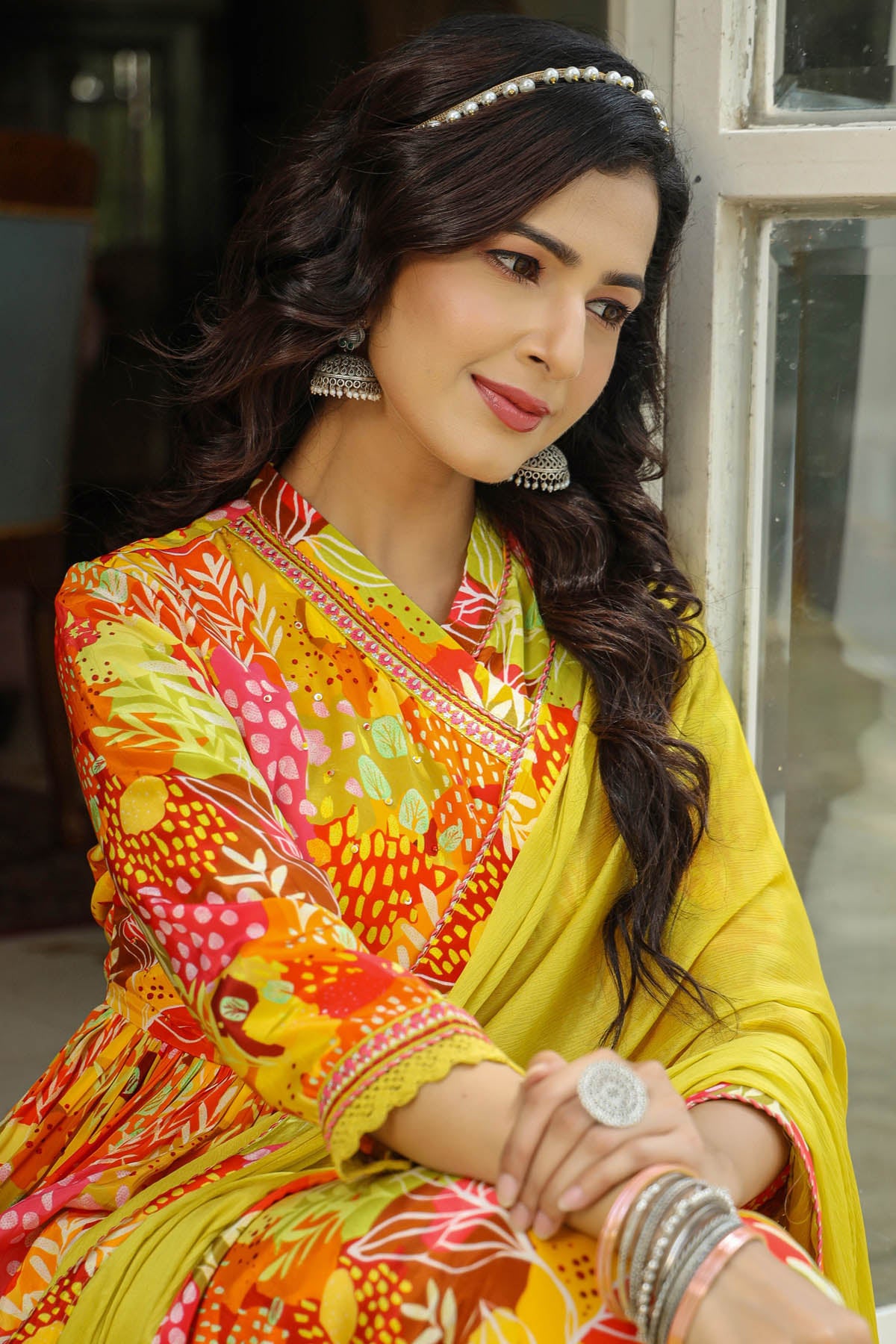 Woman wearing a colorful traditional outfit with intricate patterns.