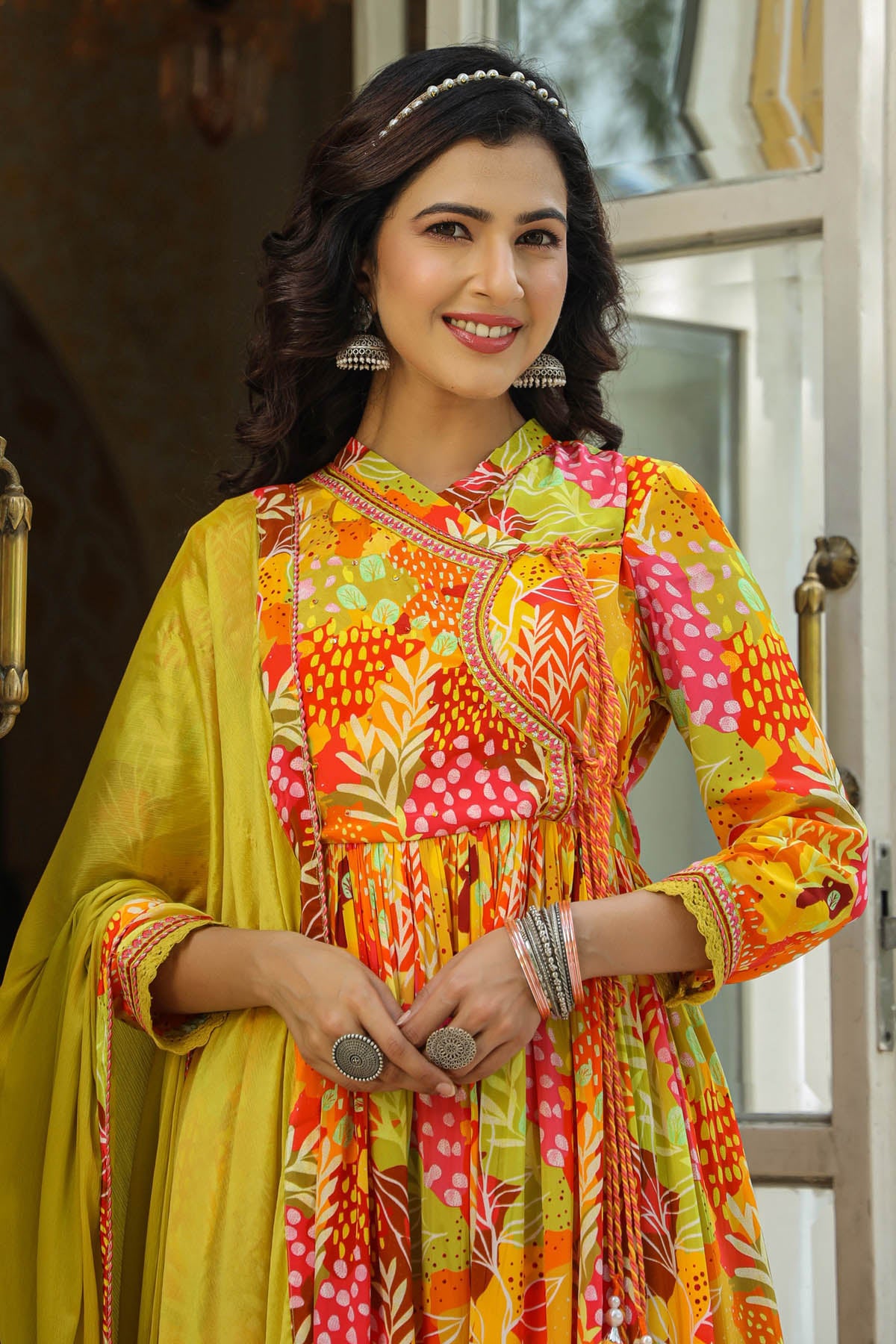 Woman wearing a colorful traditional outfit with a vibrant pattern.