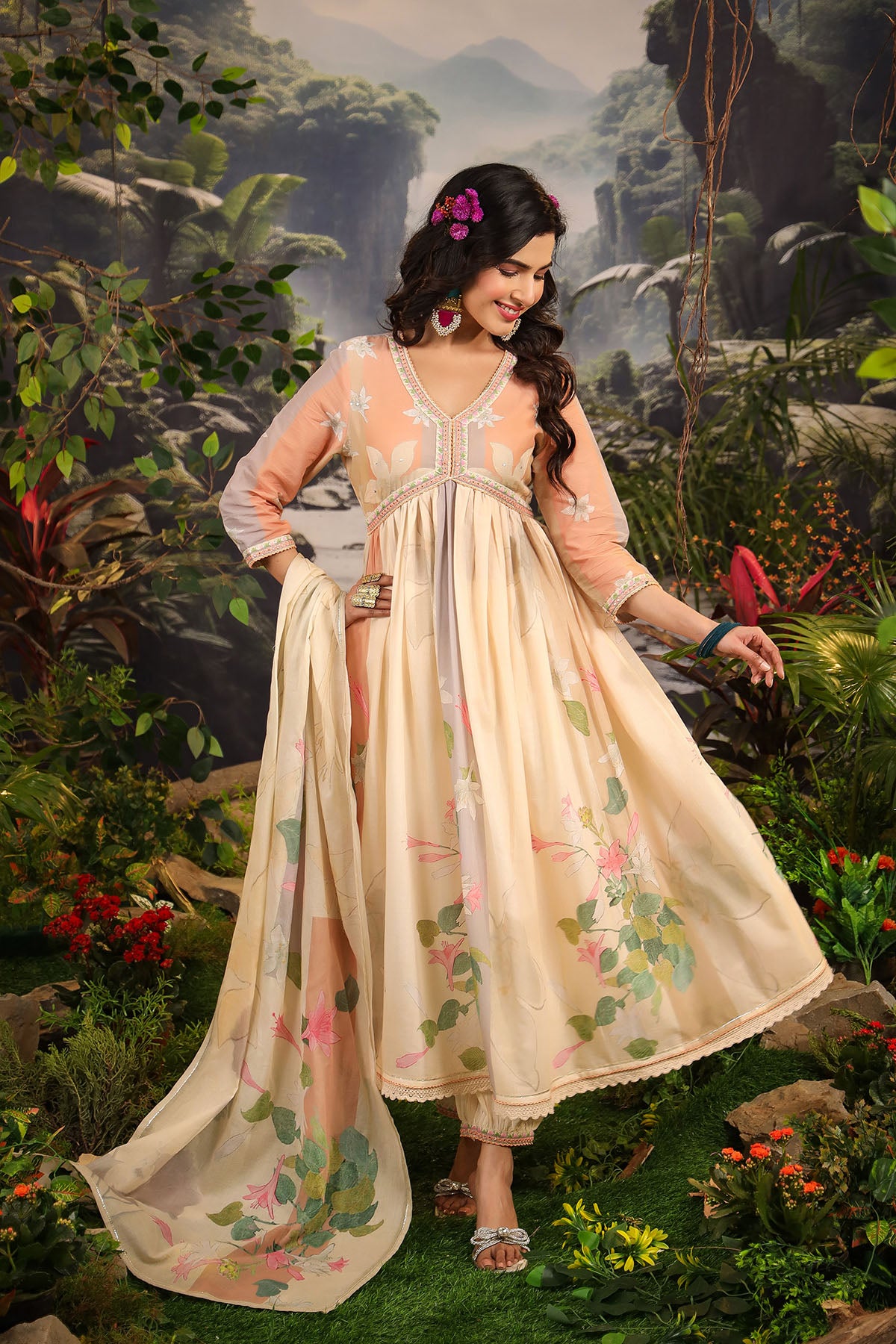 Woman in a floral dress standing in a lush green garden