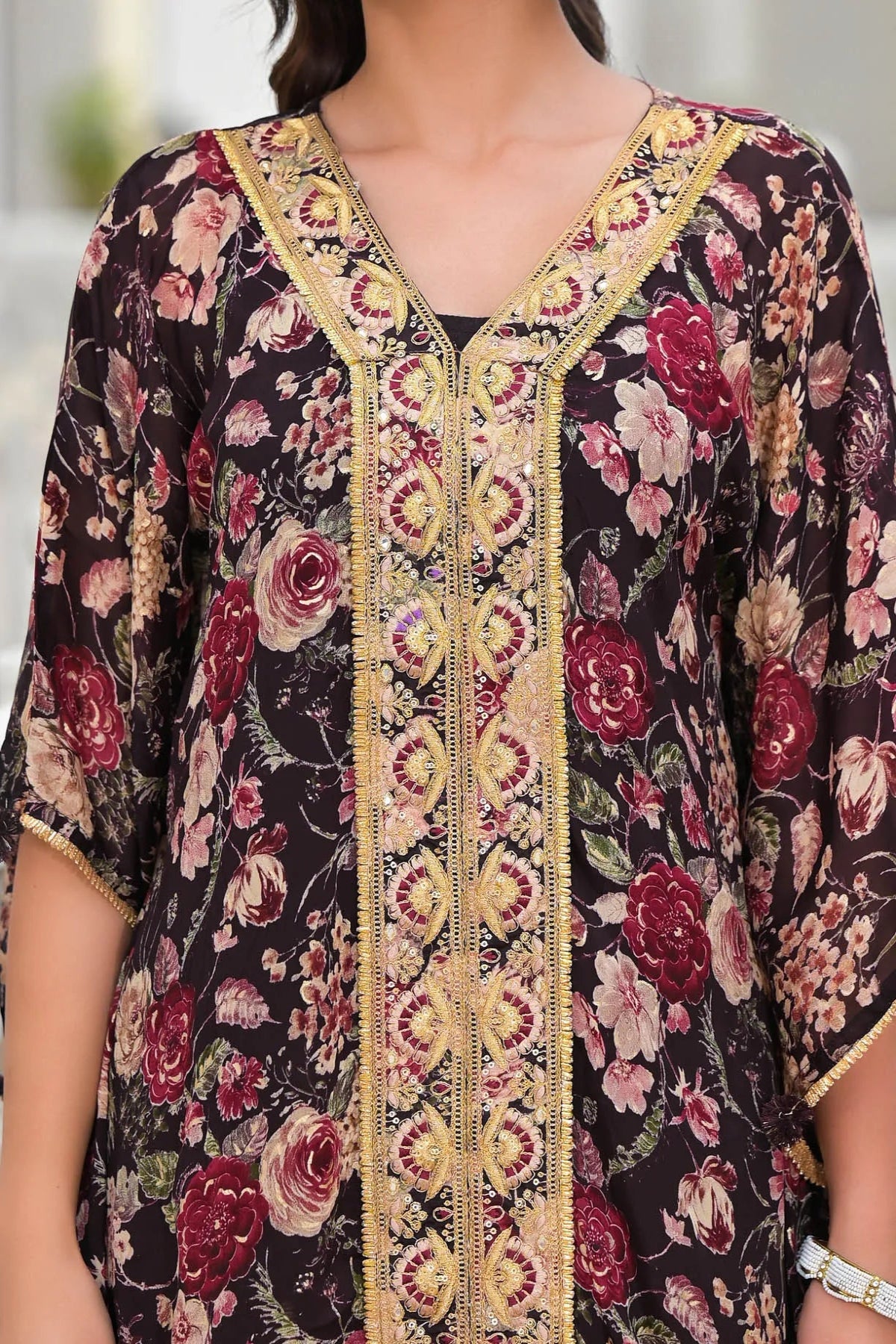 Floral patterned dress with gold embroidery on a dark background