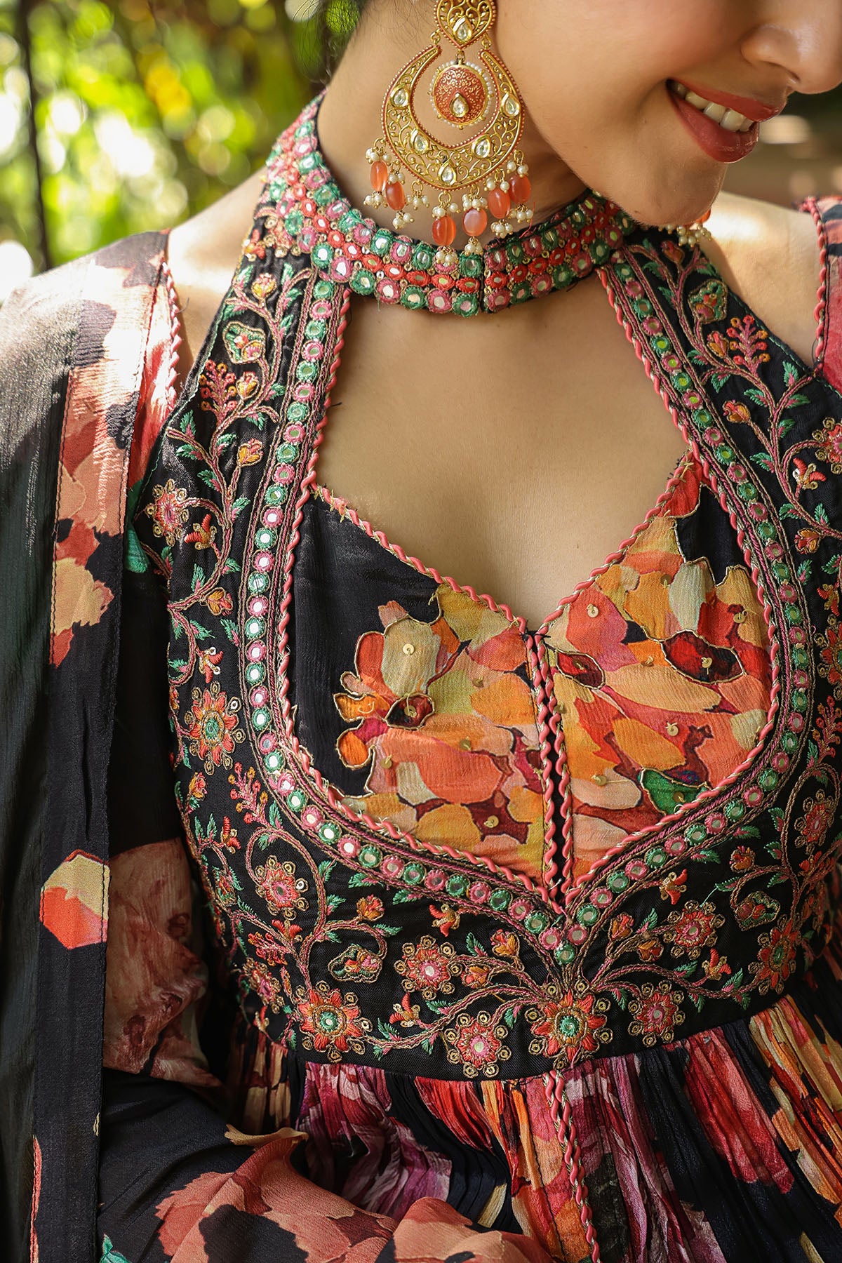 Close-up of a person wearing a colorful embroidered traditional outfit with intricate designs.